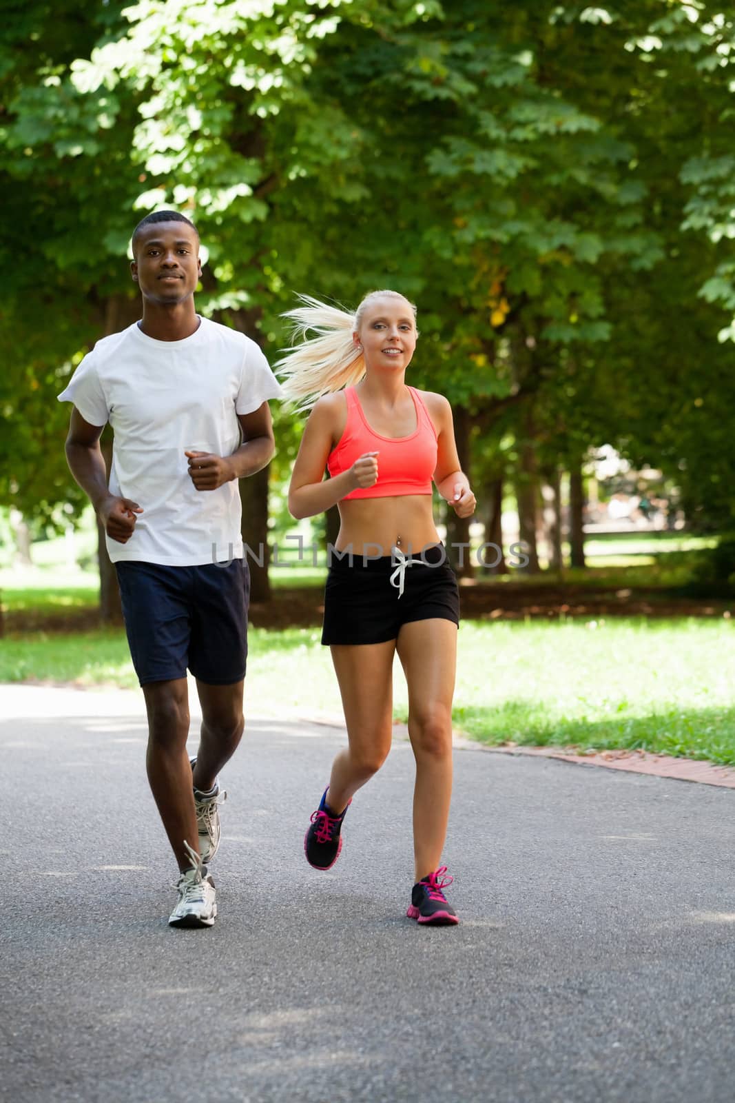 young couple runner jogger in park outdoor summer by juniart