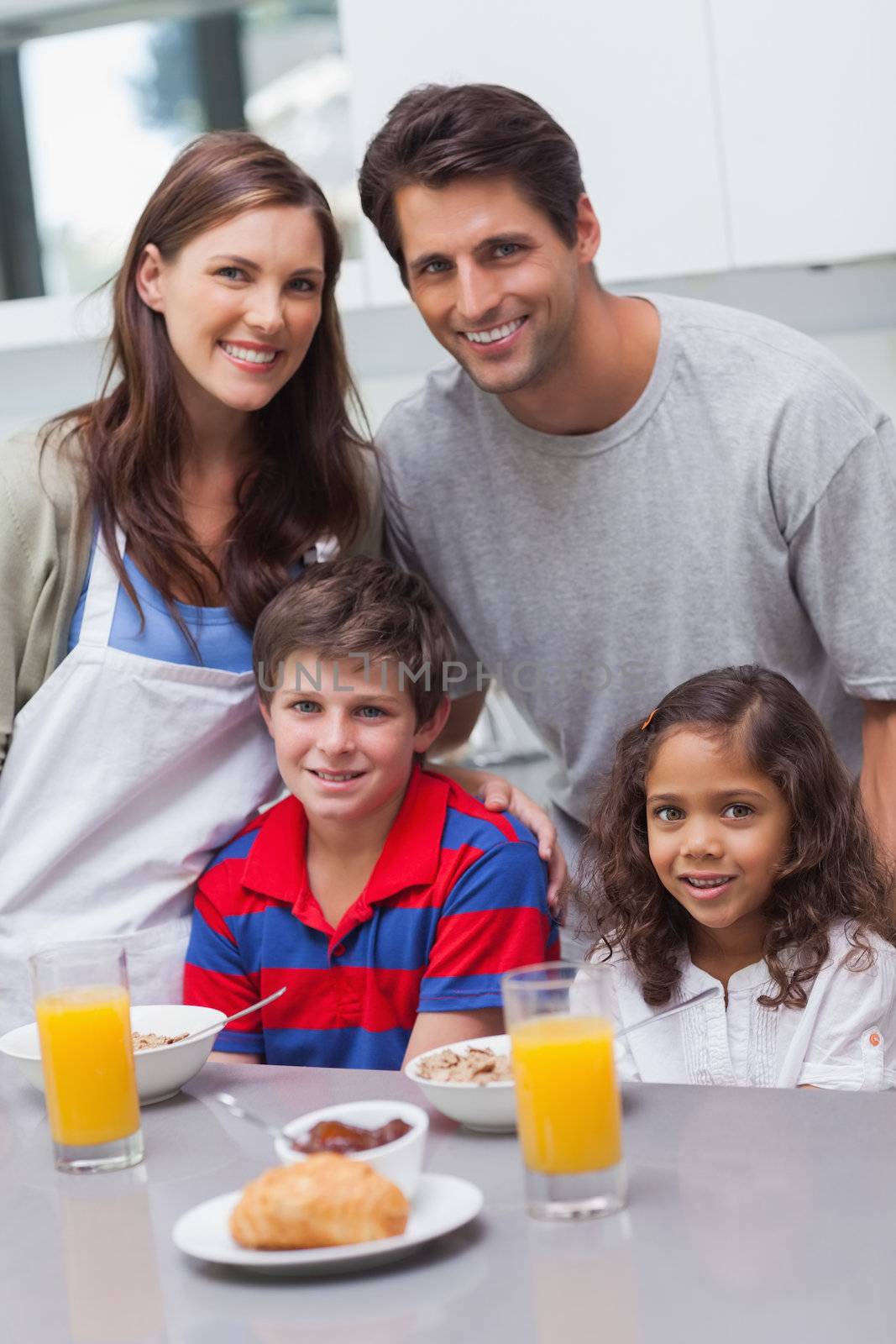 Happy family having breakfast in the kitchen