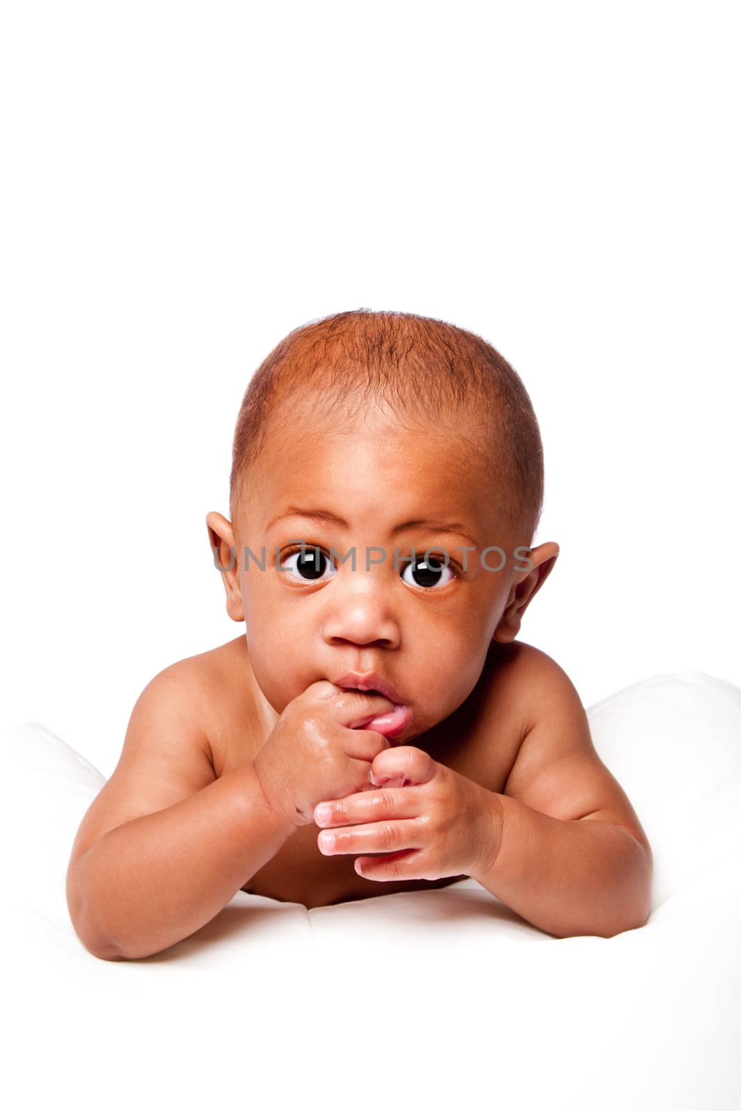 Beautiful adorable cute baby face with big eyes biting on fingers in mouth, on white.