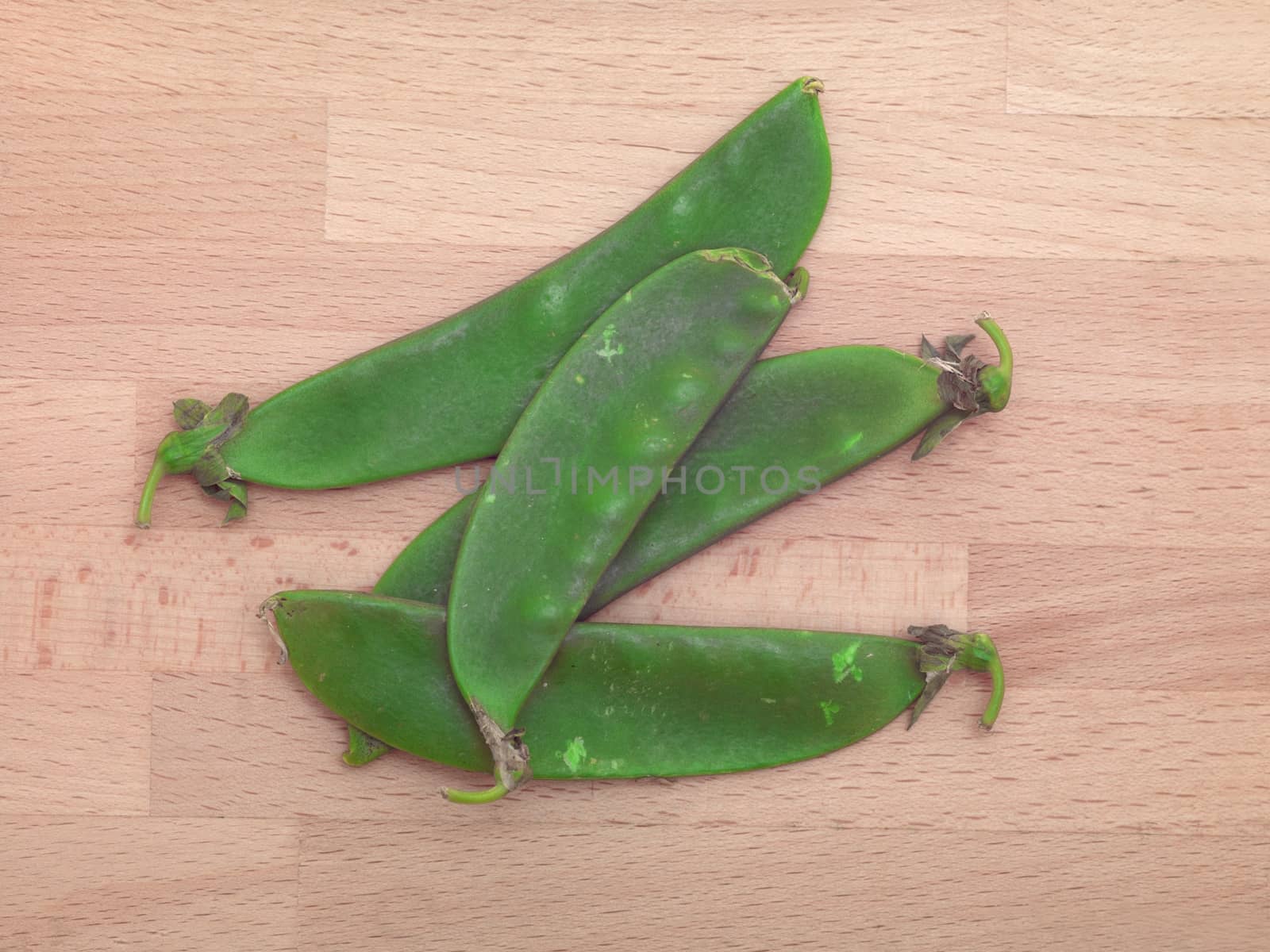 Split peas isolated on a wooden chopping board