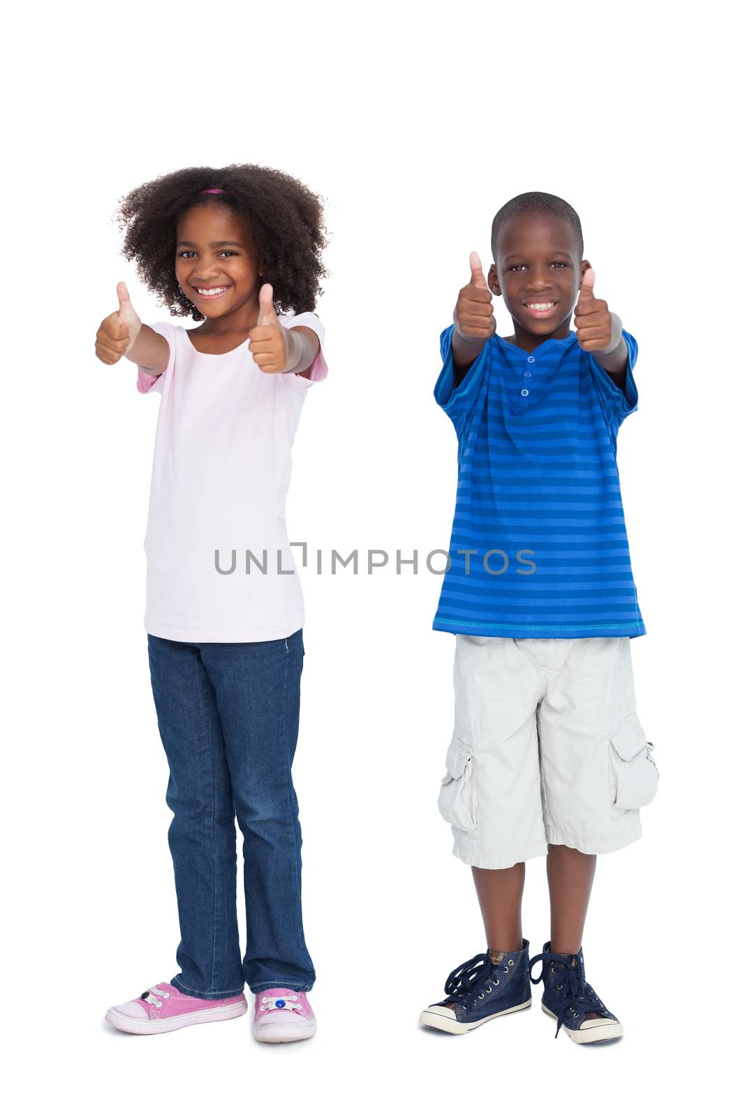 Brother and sister with thumbs up by Wavebreakmedia