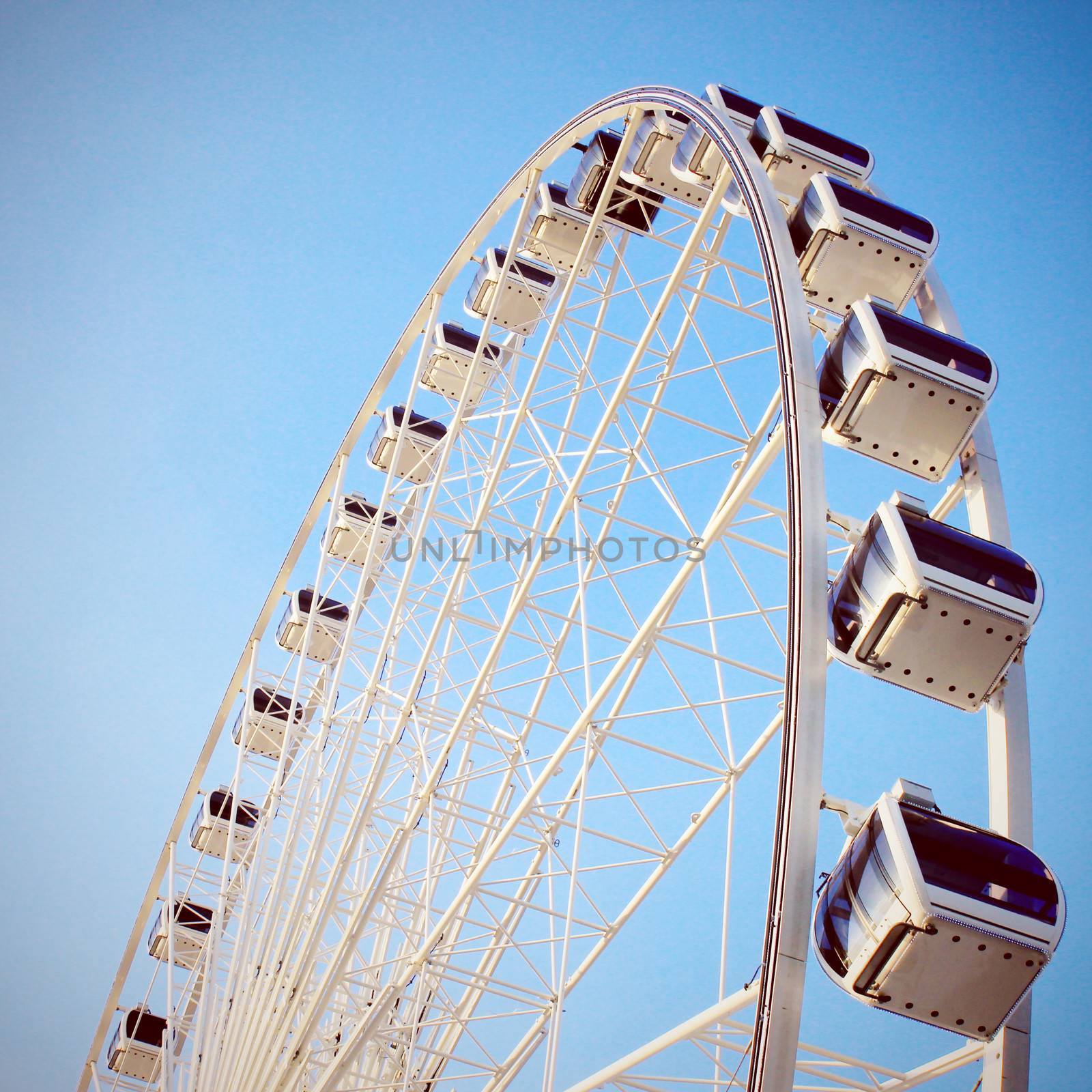 Ferris wheel with clear blue sky, retro filter effect