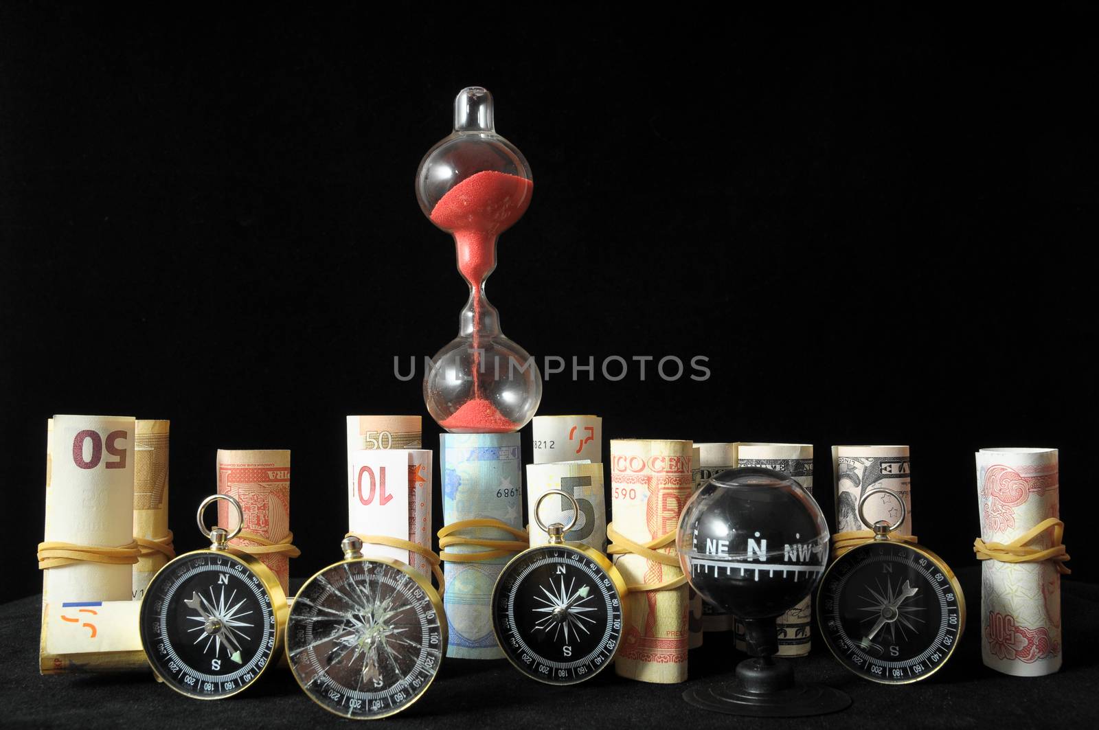 Business Time Concept Money and Hourglass on a Black Background