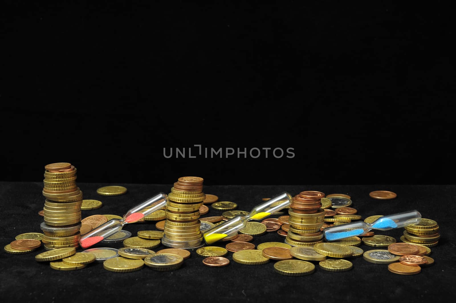 Business Time Concept Money and Hourglass on a Black Background