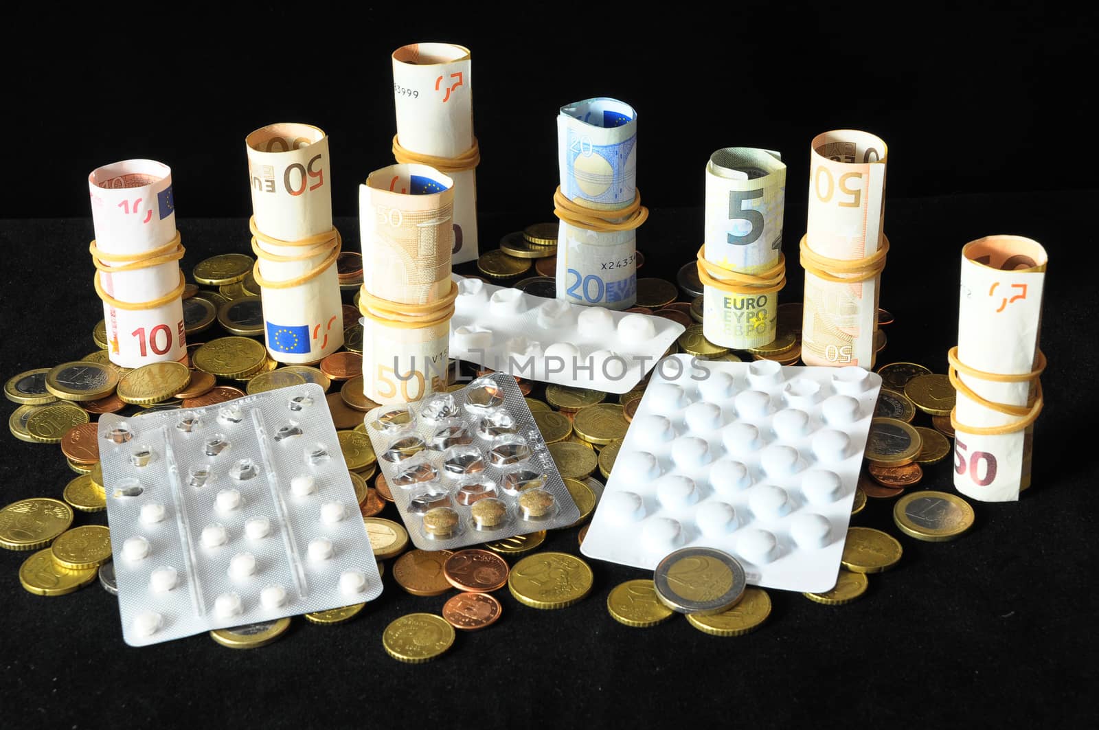 Some Pills And Money on a Black Background