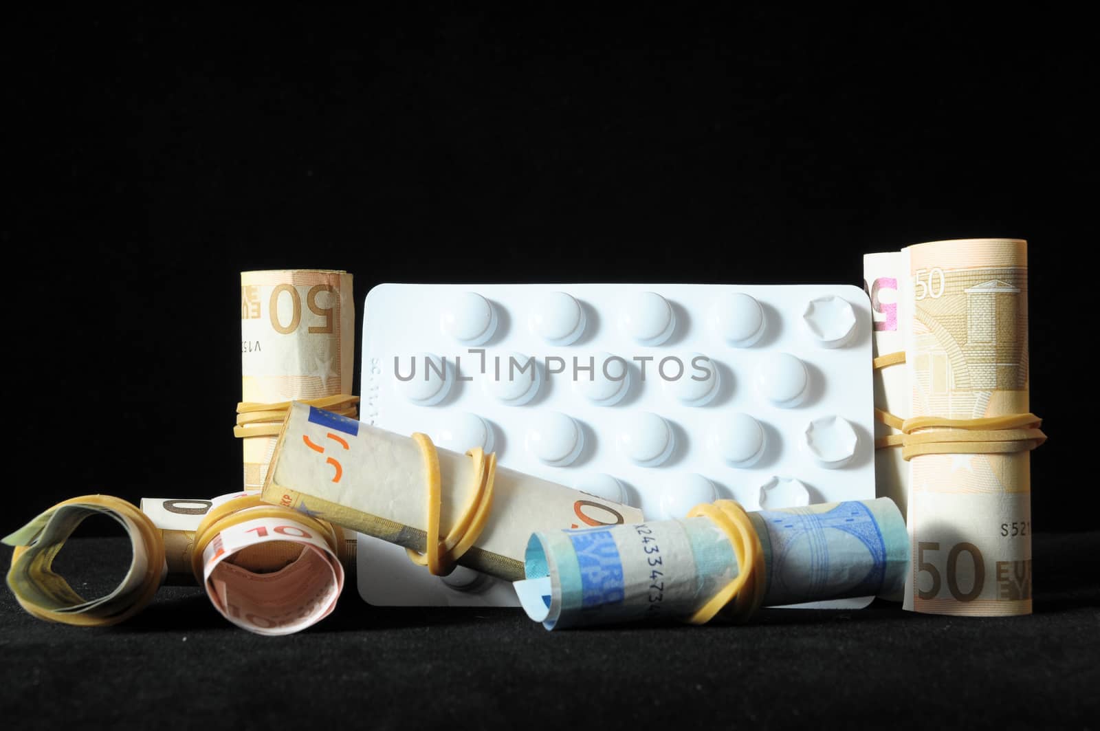 Some Pills And Money on a Black Background