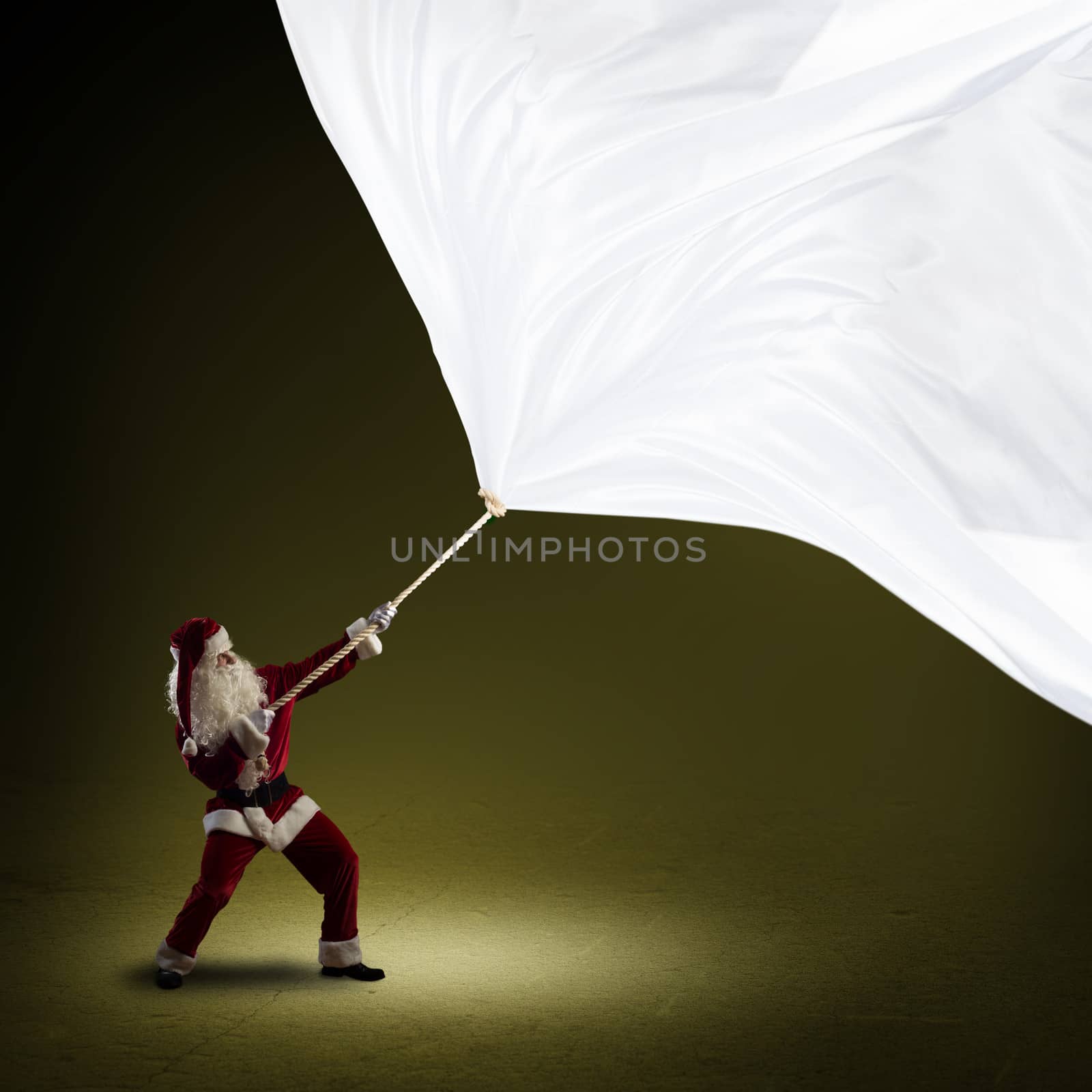 Santa Claus pulls a banner of cloth with a rope, place for text