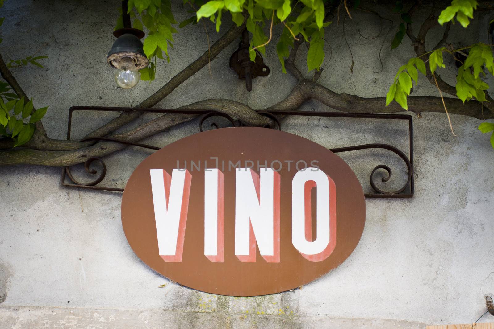Close up of an old sign saying Vino on a bar in Italy