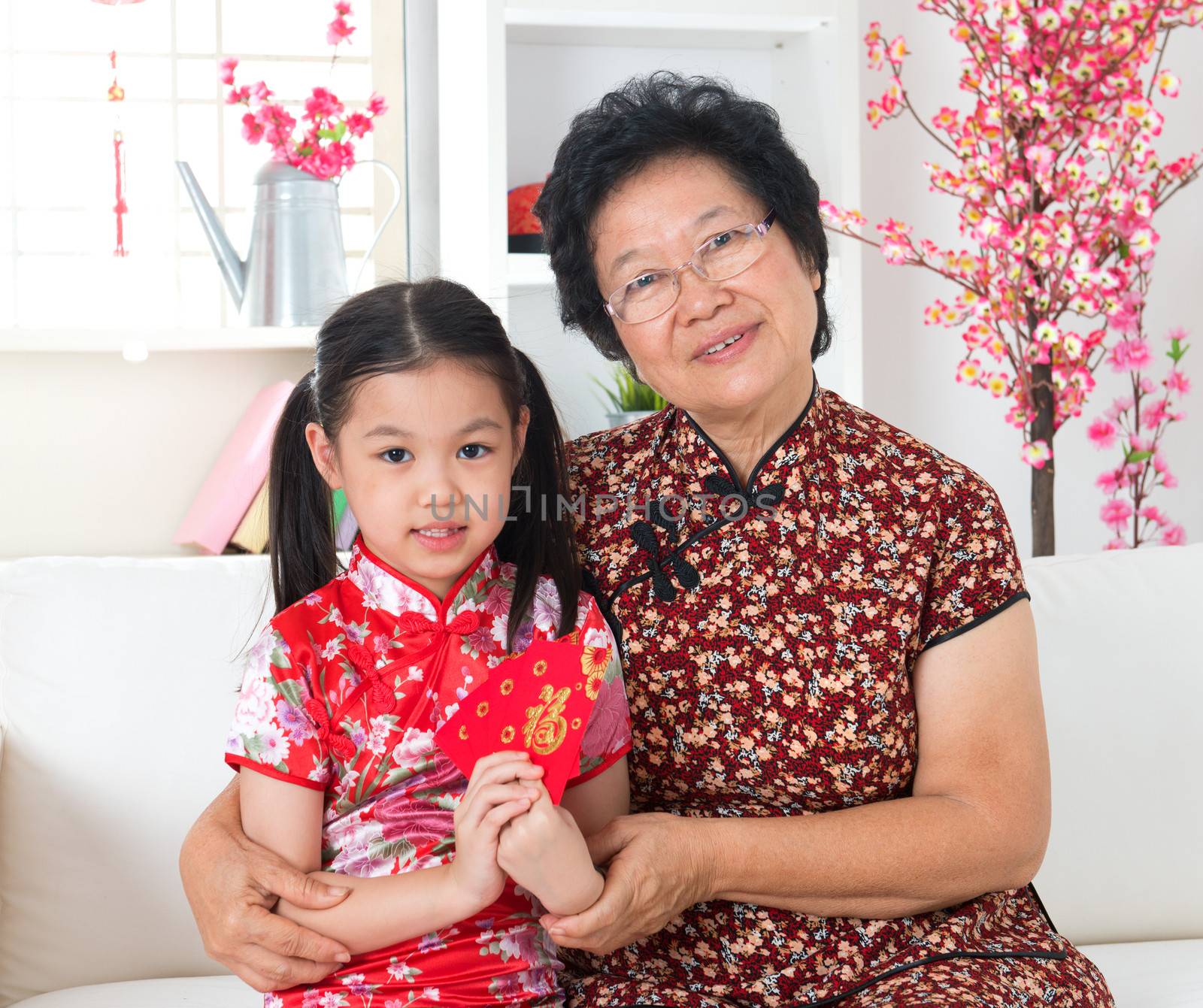 Beautiful grandparent and grandchild celebrate Chinese new year at home.