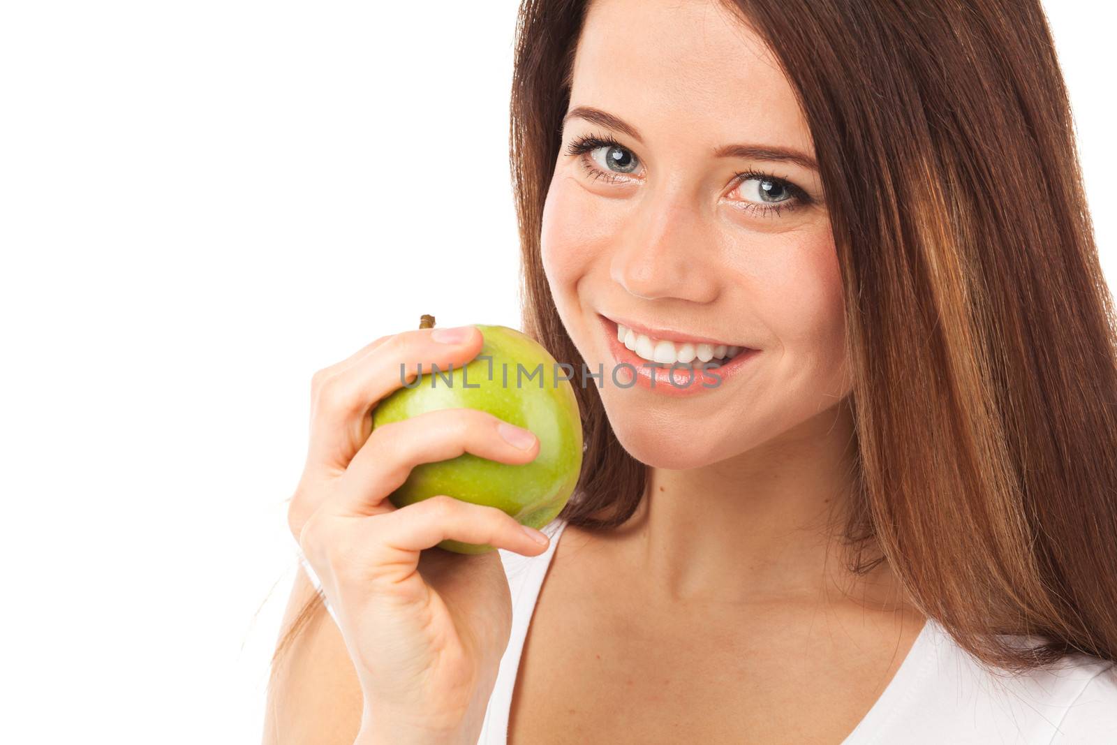 Pretty young woman eating a green apple, isolated on white
