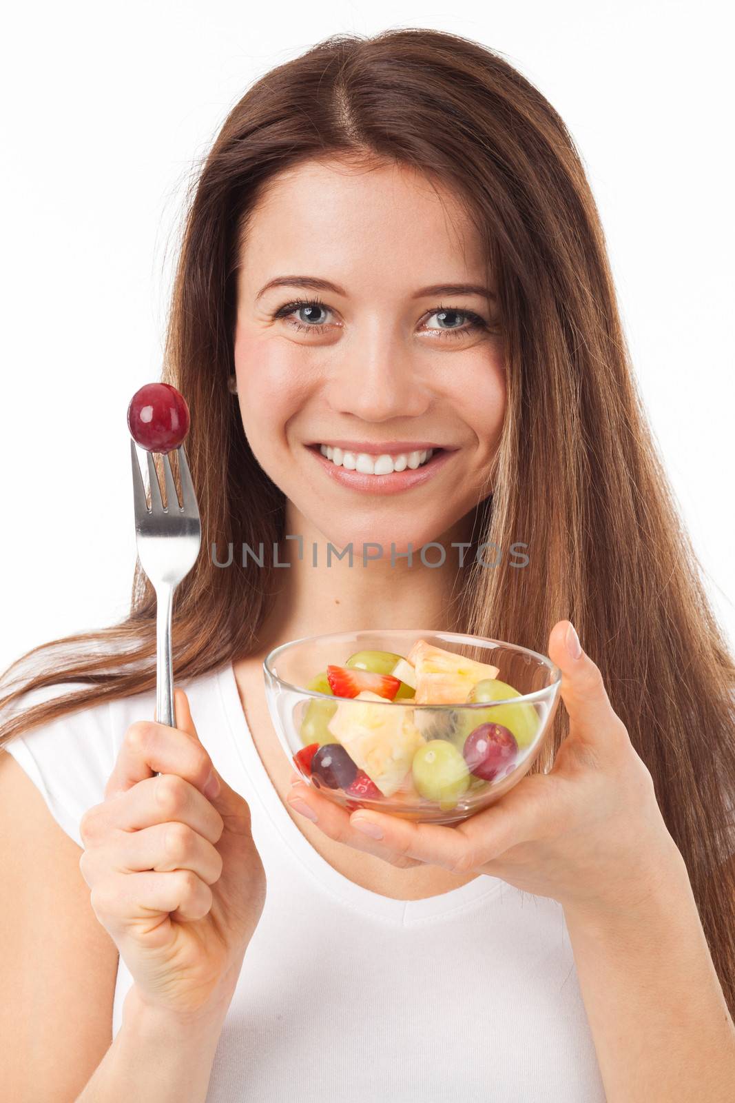 Close up portrait of a beautiful woman eating fruits, isolated on white