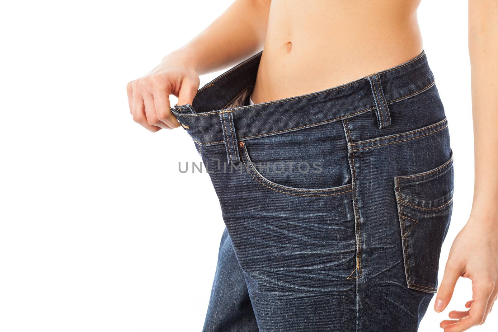 Young woman showing how much weight she lost, isolated on white