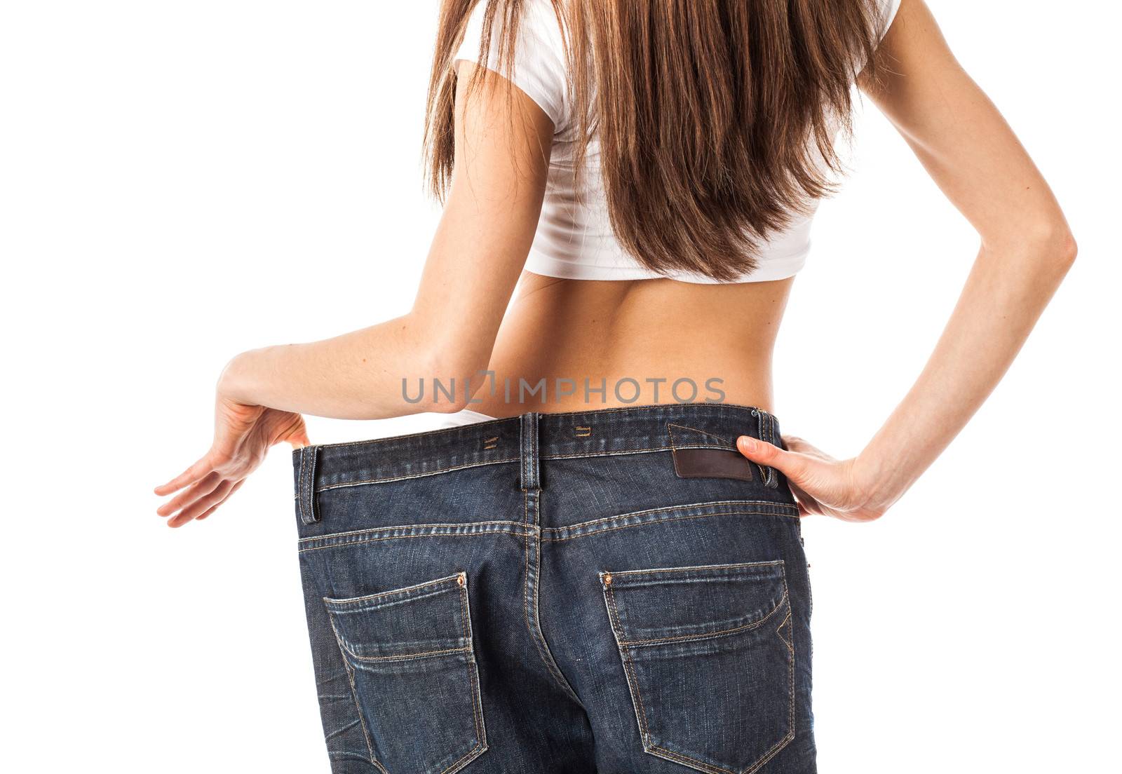 Woman from back showing how much weight she lost, isolated on white