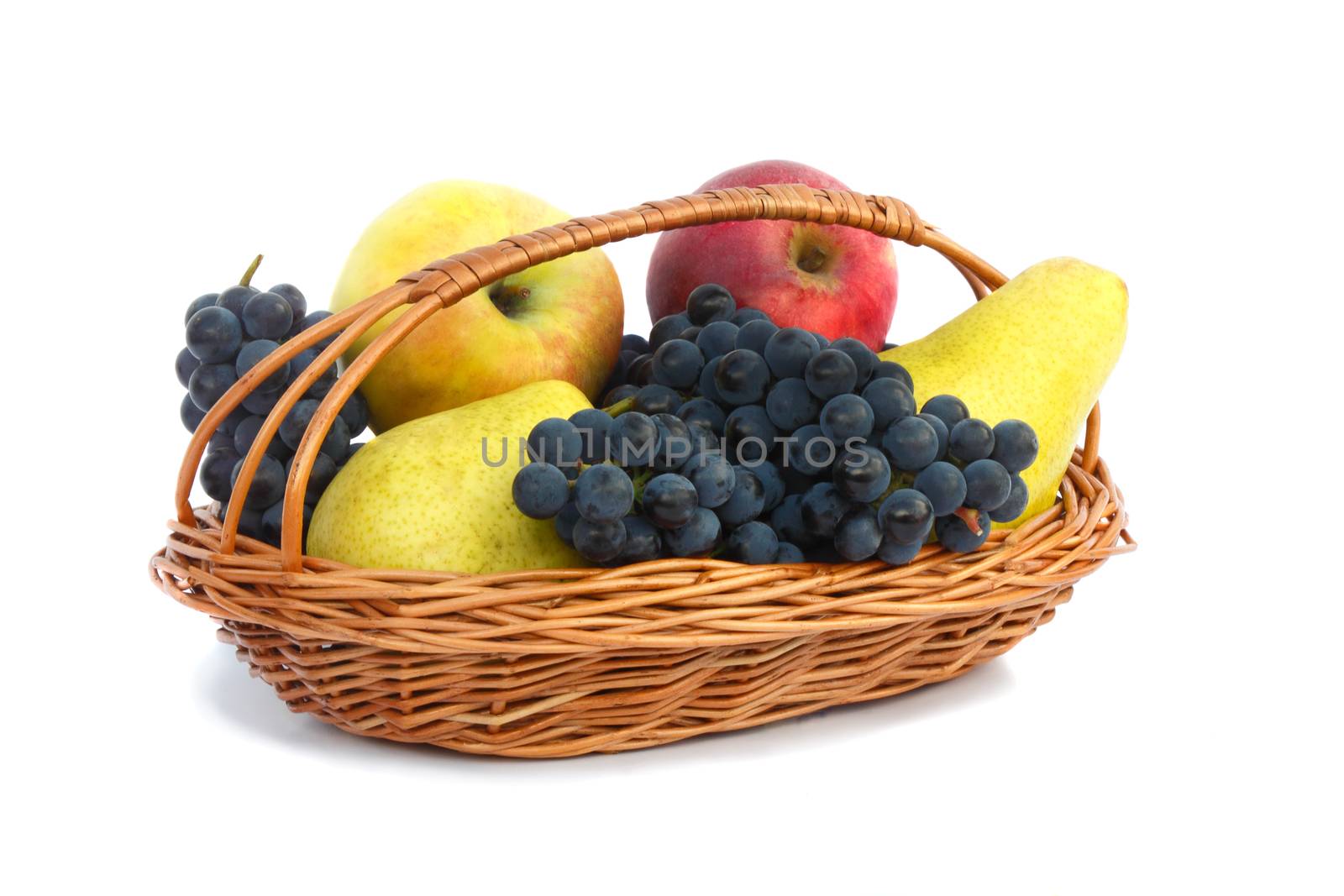 Ripe pears, apples and grapes in a wicker basket. Presented on a white background.