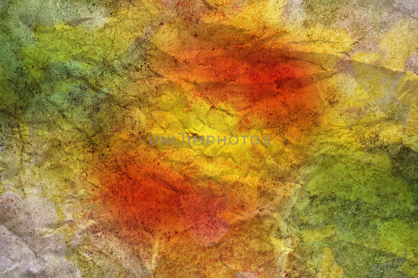 A crinkled stone texture overlaid with softly blended red, yellow and green hues to make a colourful abstract background.