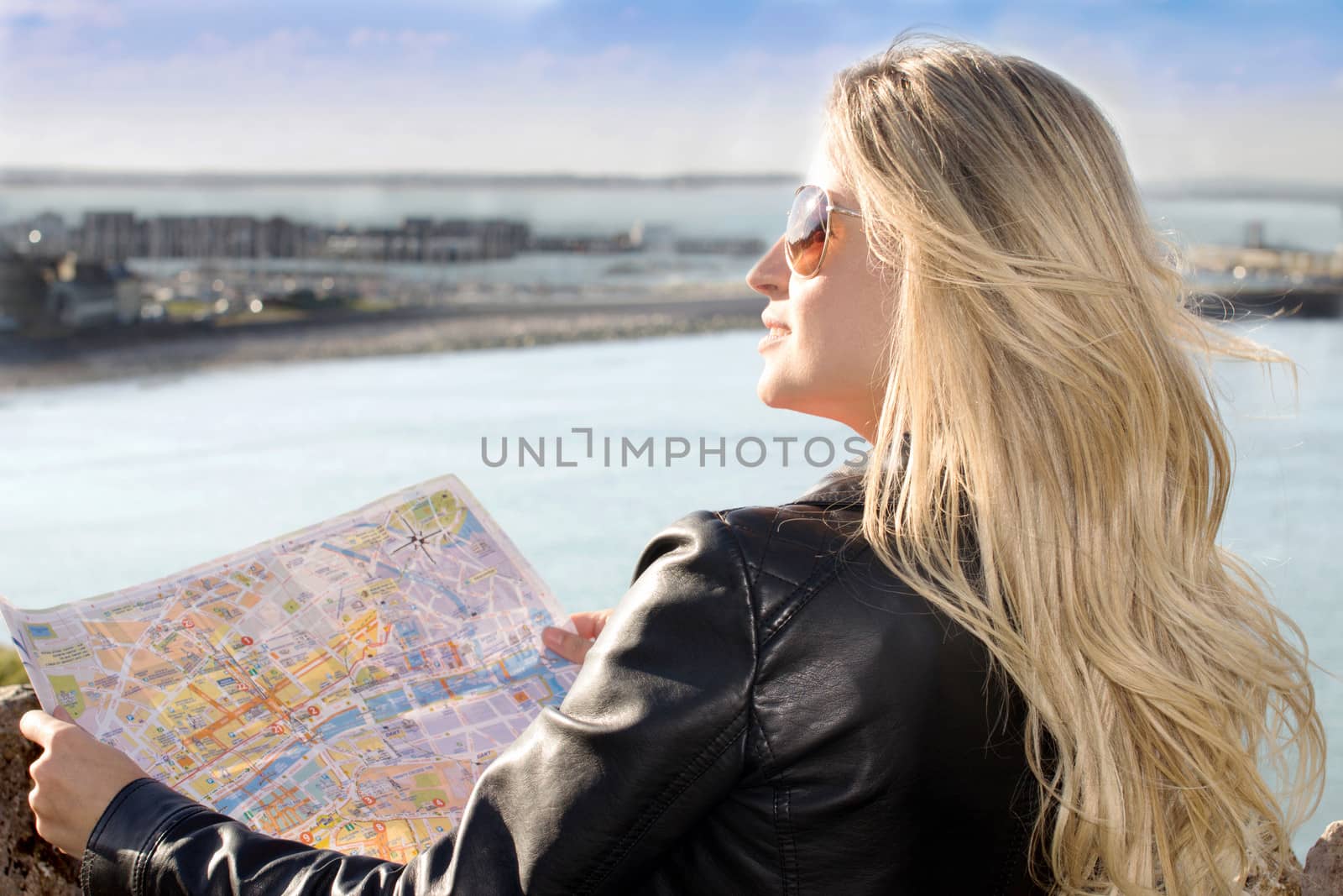 Beautiful woman looking the landscape holding a map