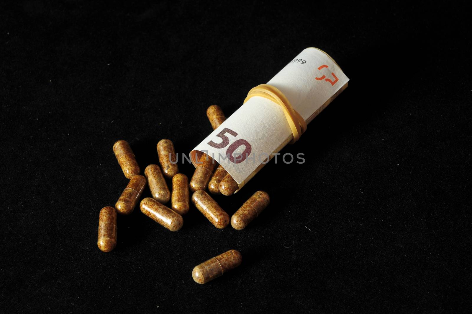 Some Pills And Money on a Black Background