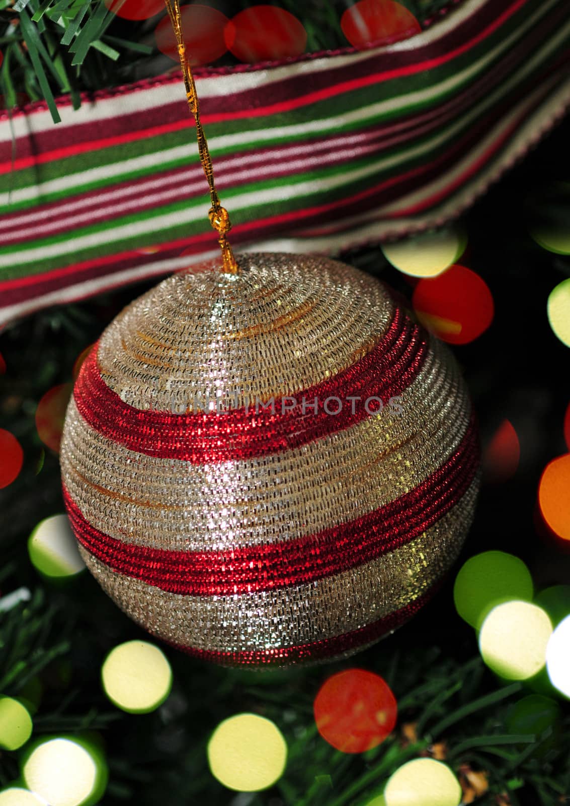 red and silver ornament with christmas lights on tree