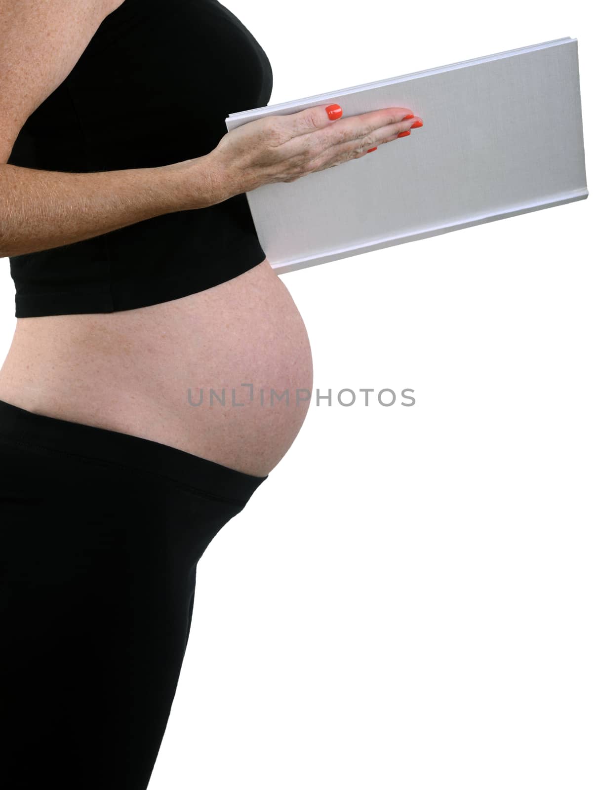 woman reading book to pregnant stomach and unborn baby during pregnancy