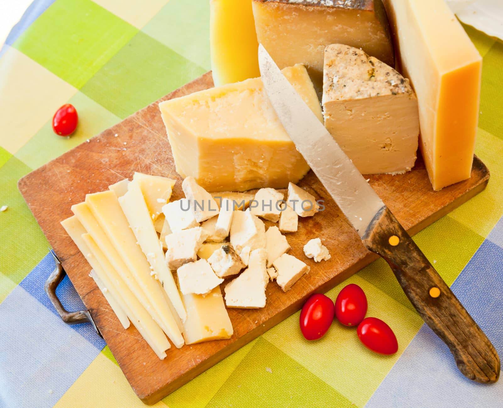 Pecorino sardo cheese slices on wooden board