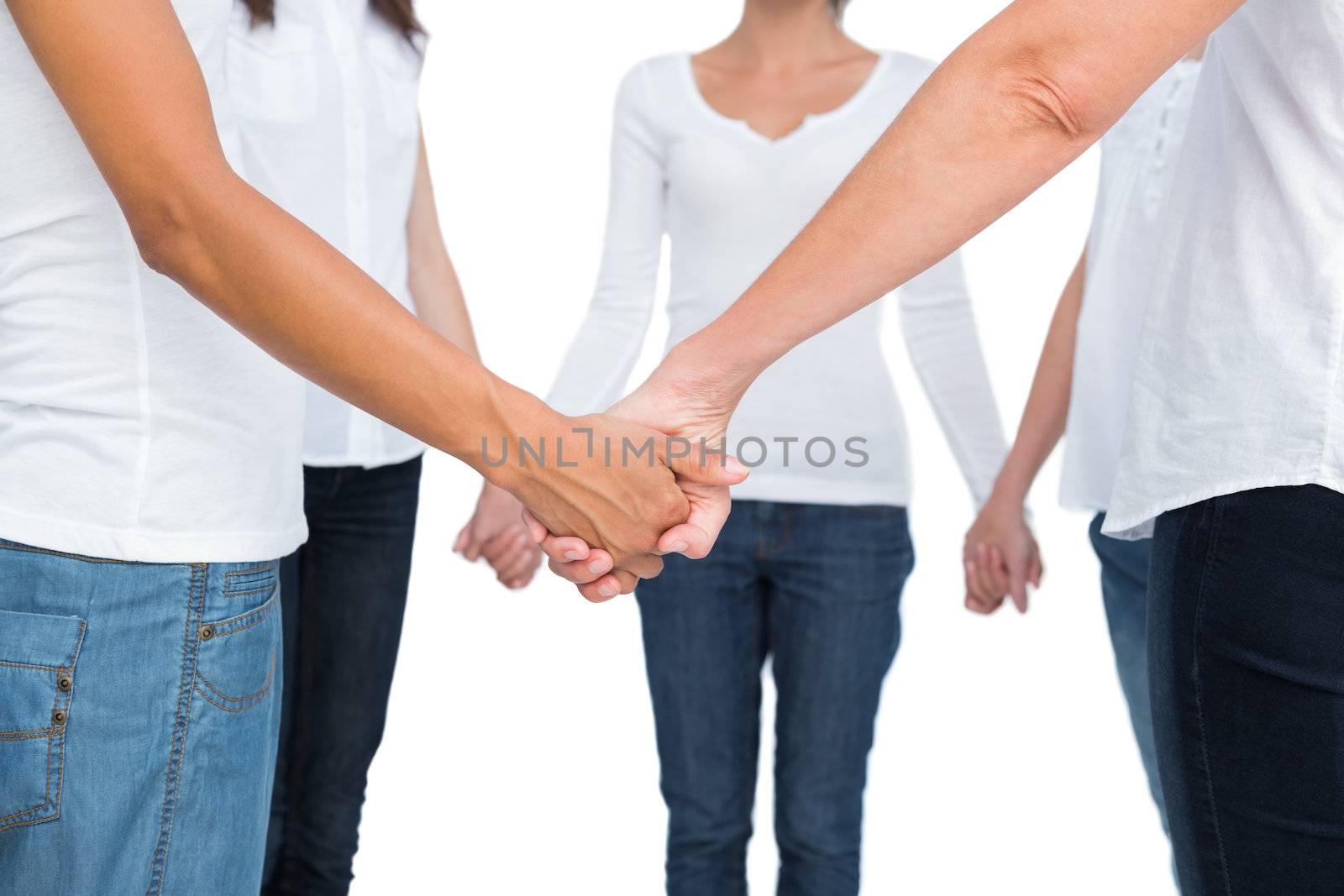 Female hands joined in a circle on white background