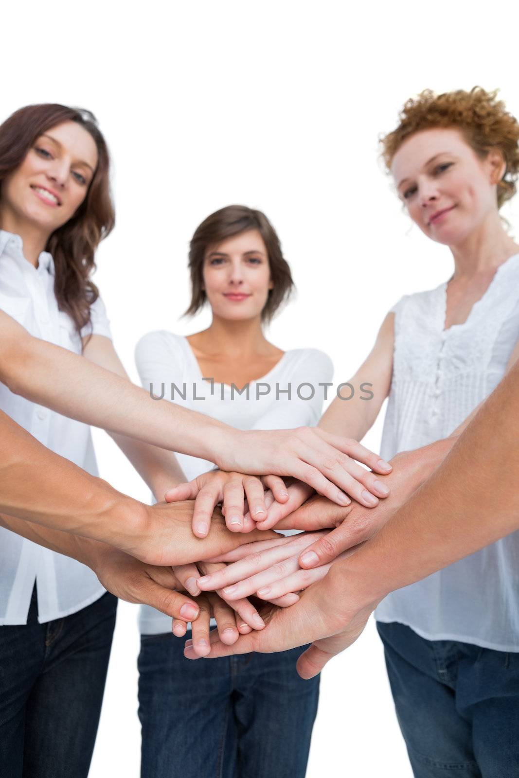 Peaceful women joining hands in a circle on white background