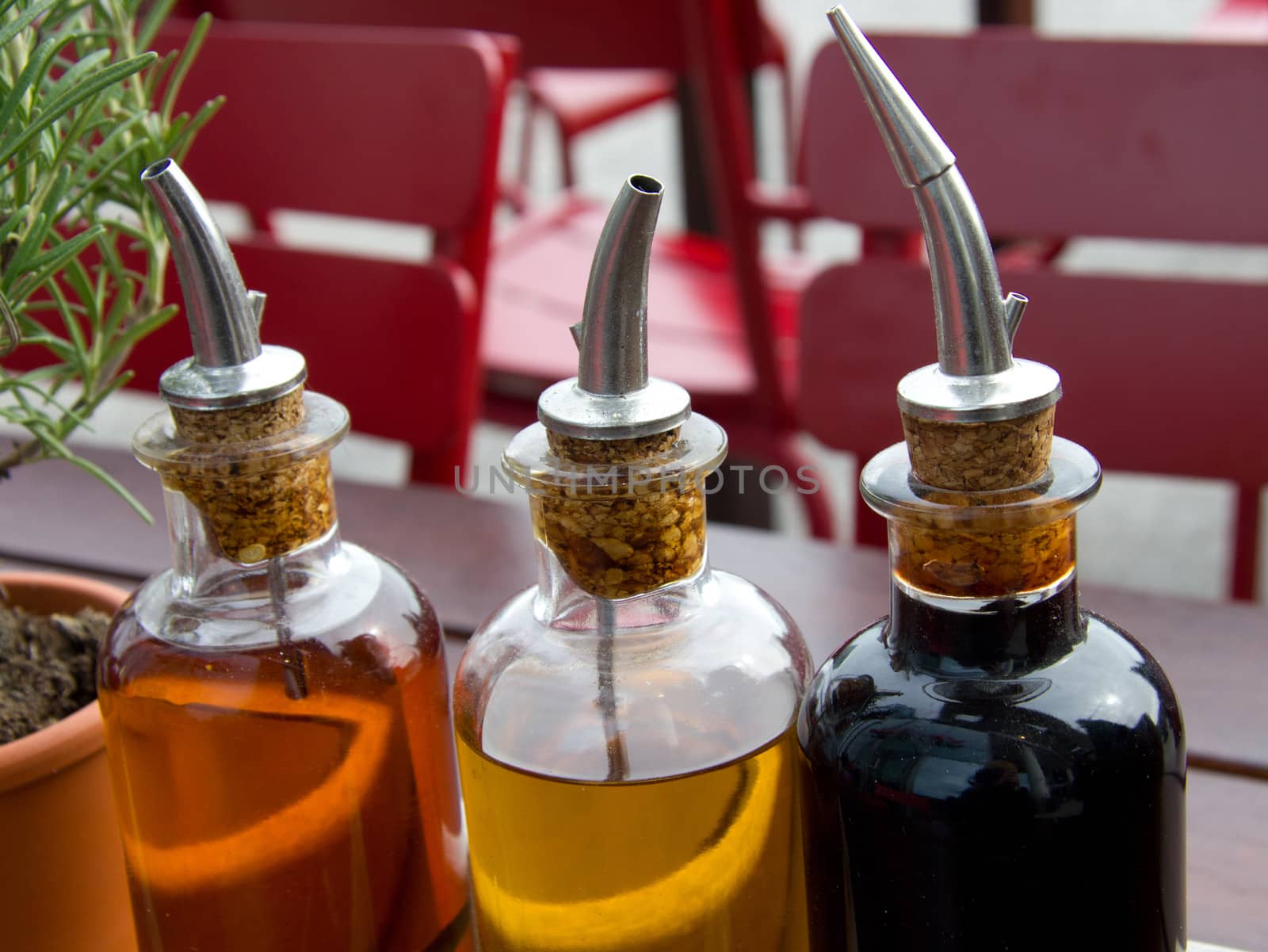 balsamic vinegar bottles and condiments on the table in an open cafe