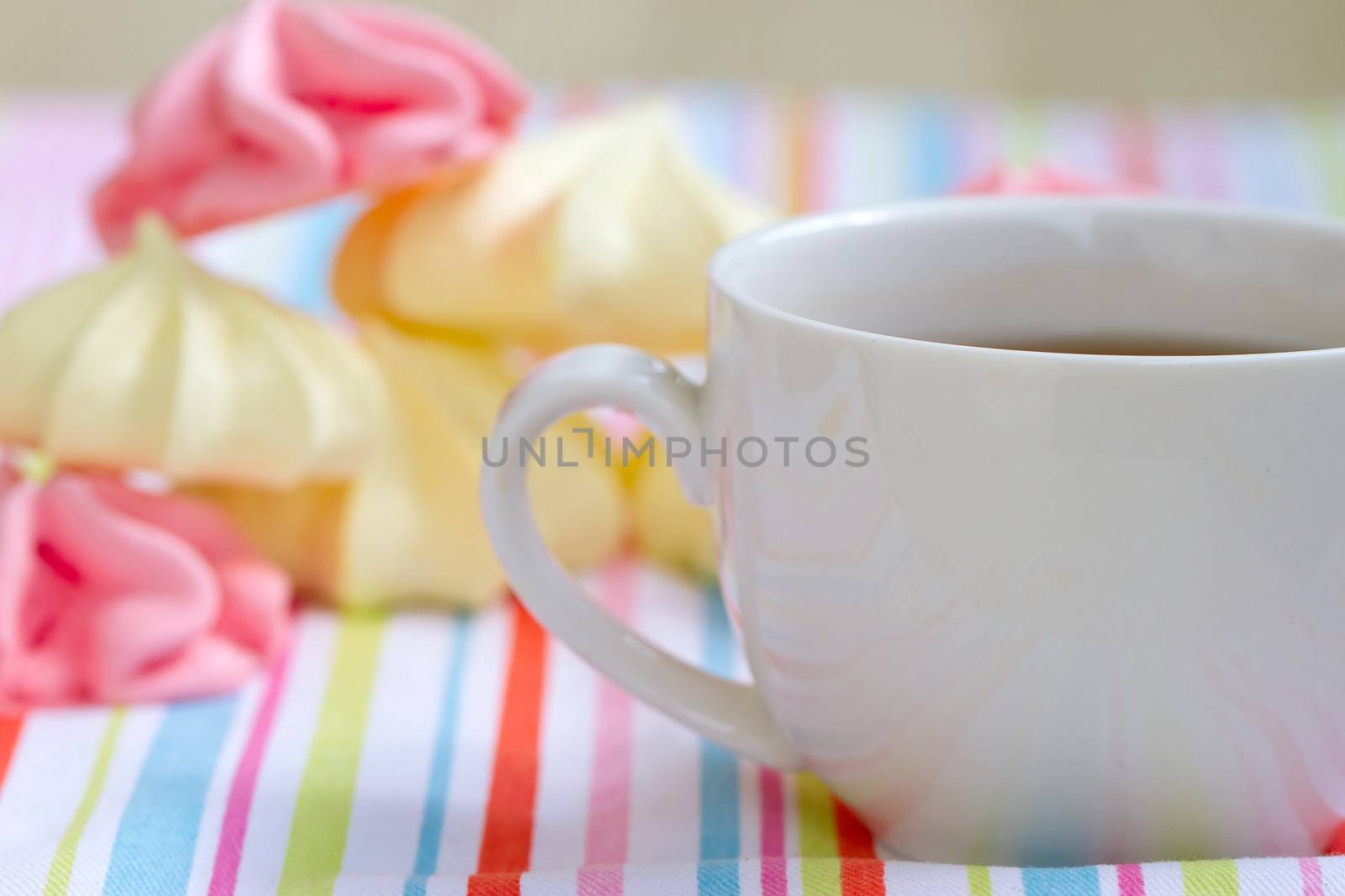 Pink colored meringue and a teacup