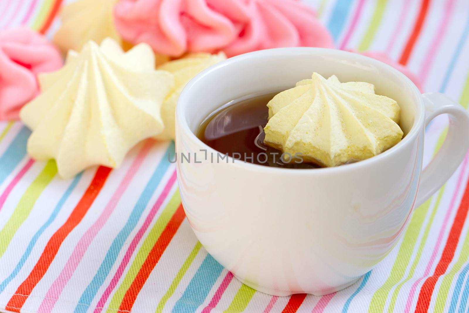 Pink colored meringue and a teacup