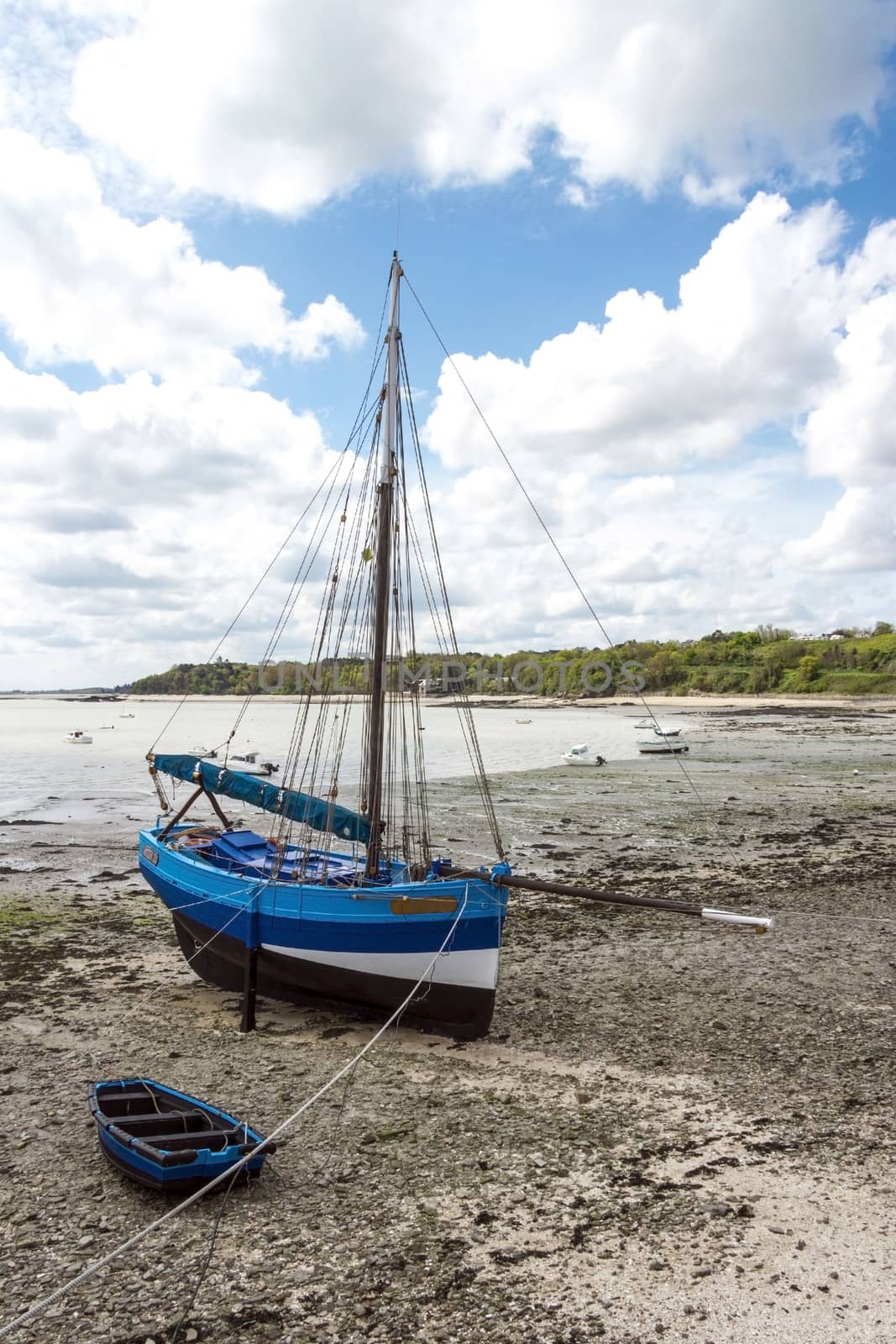 Blue boat at time of low tide, northern coast of France