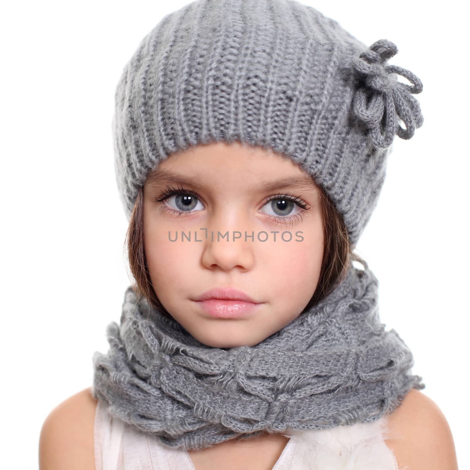 little girl in a knitted hat and gray scarf by andersonrise