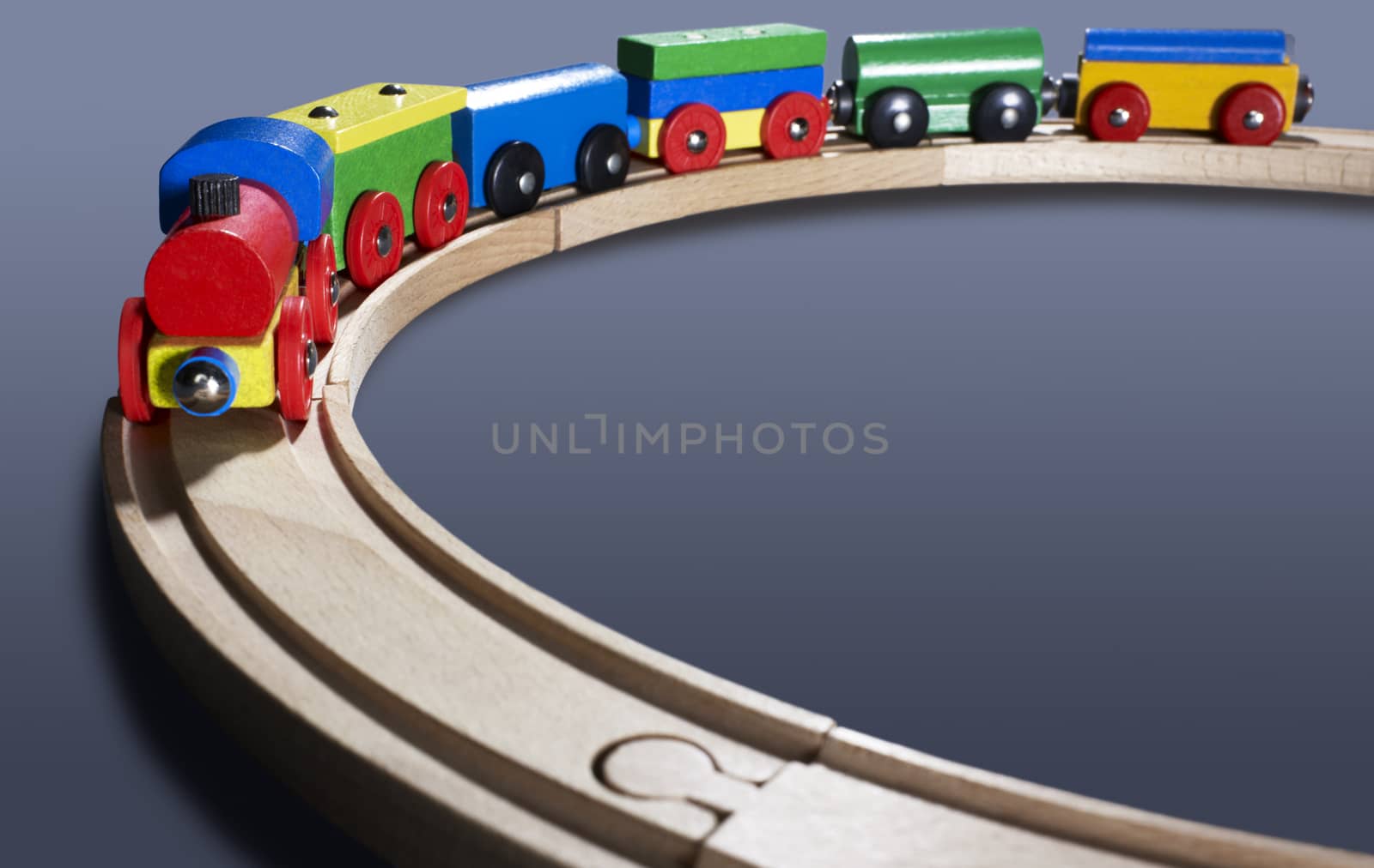 dynamic studio photography of a colorful wooden toy train dark back