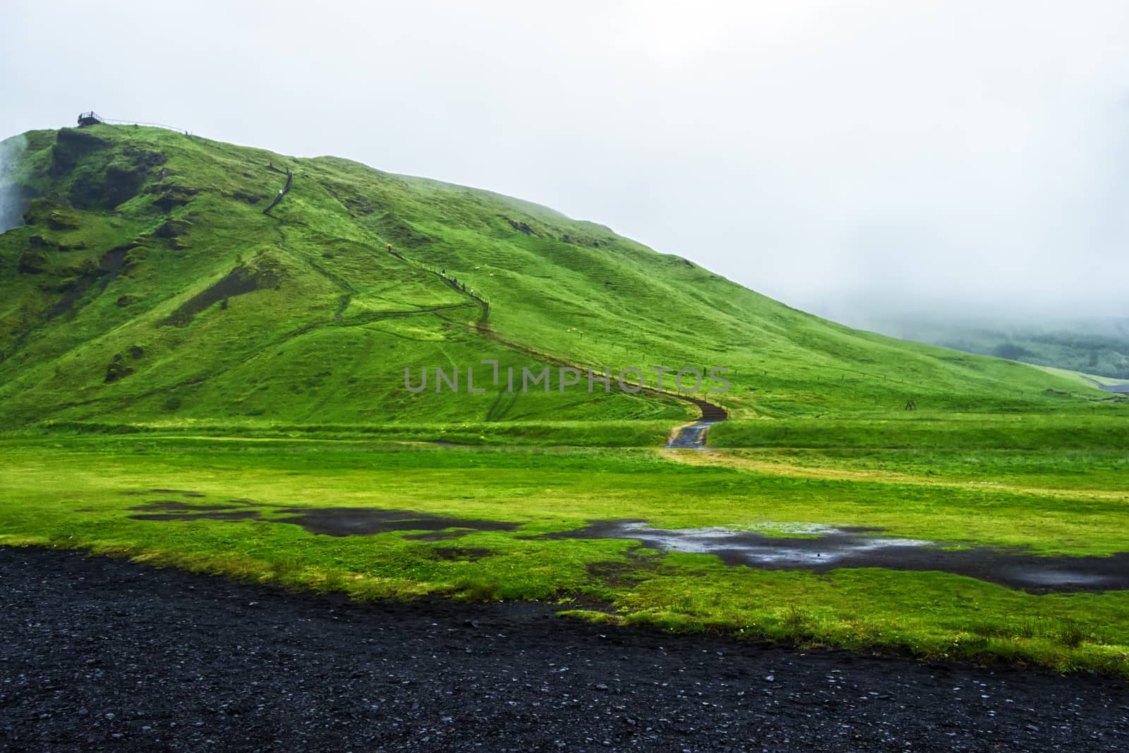 Road near Skogafoss waterfall in Iceland,  rainy summer