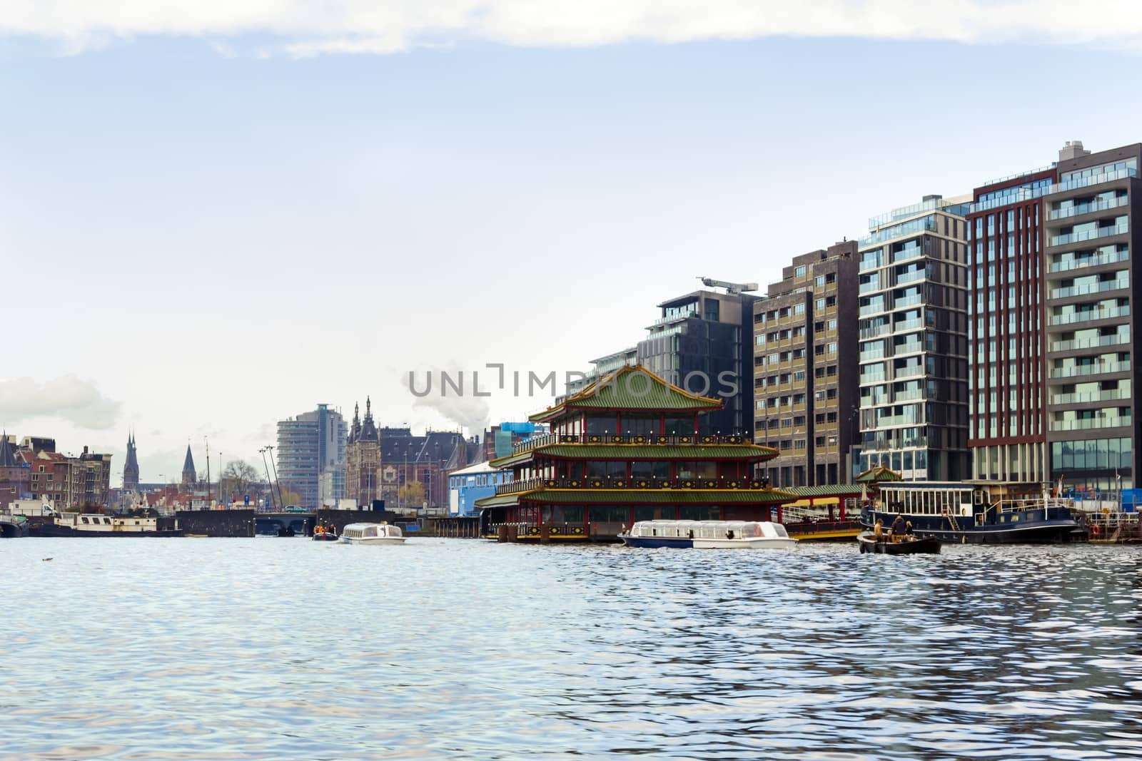 View at the Amsterdam central station from the water in the Netherlands