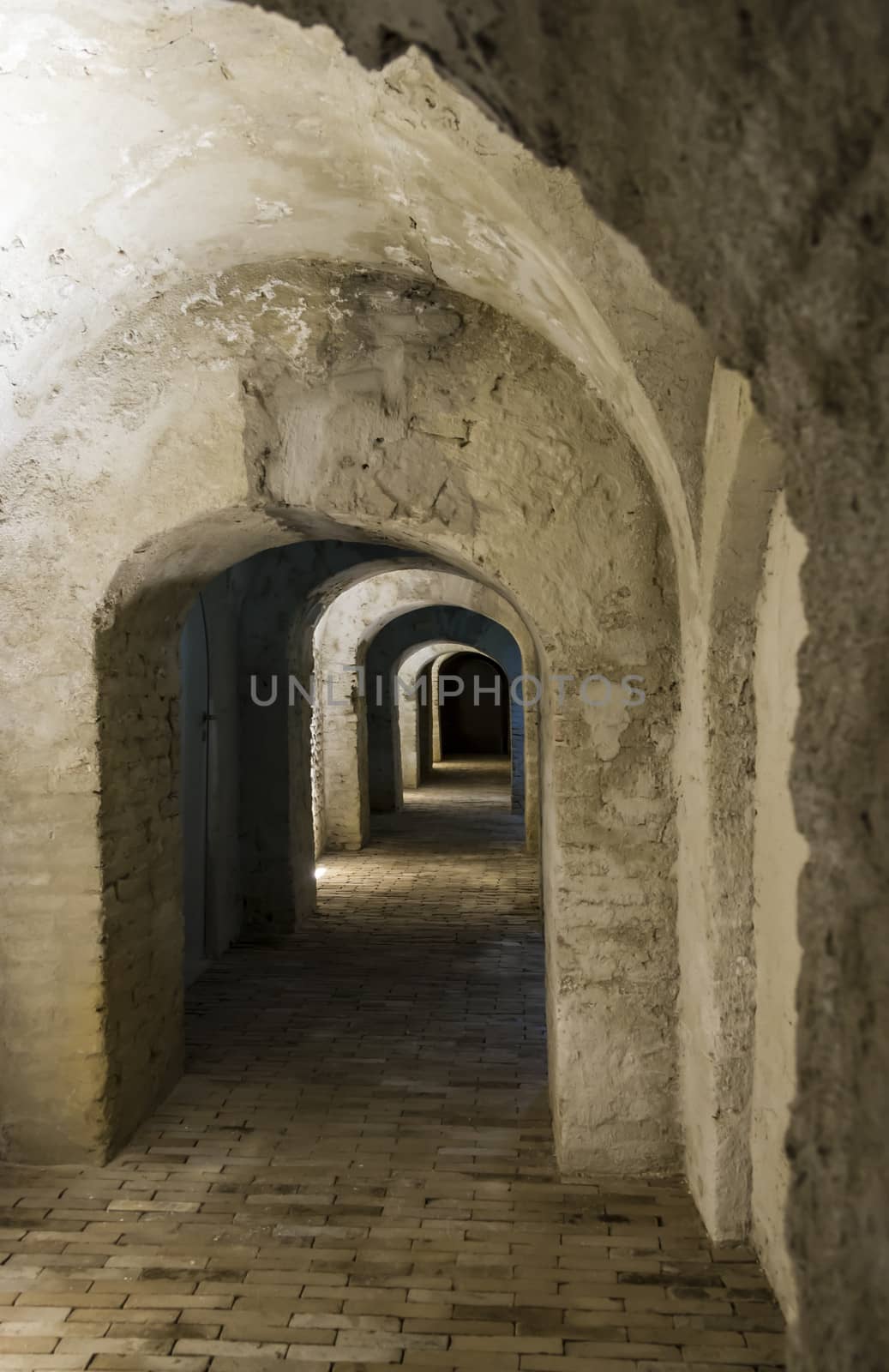 illuminated hallway in the dungeon of an old building in Amsterd by Tetyana