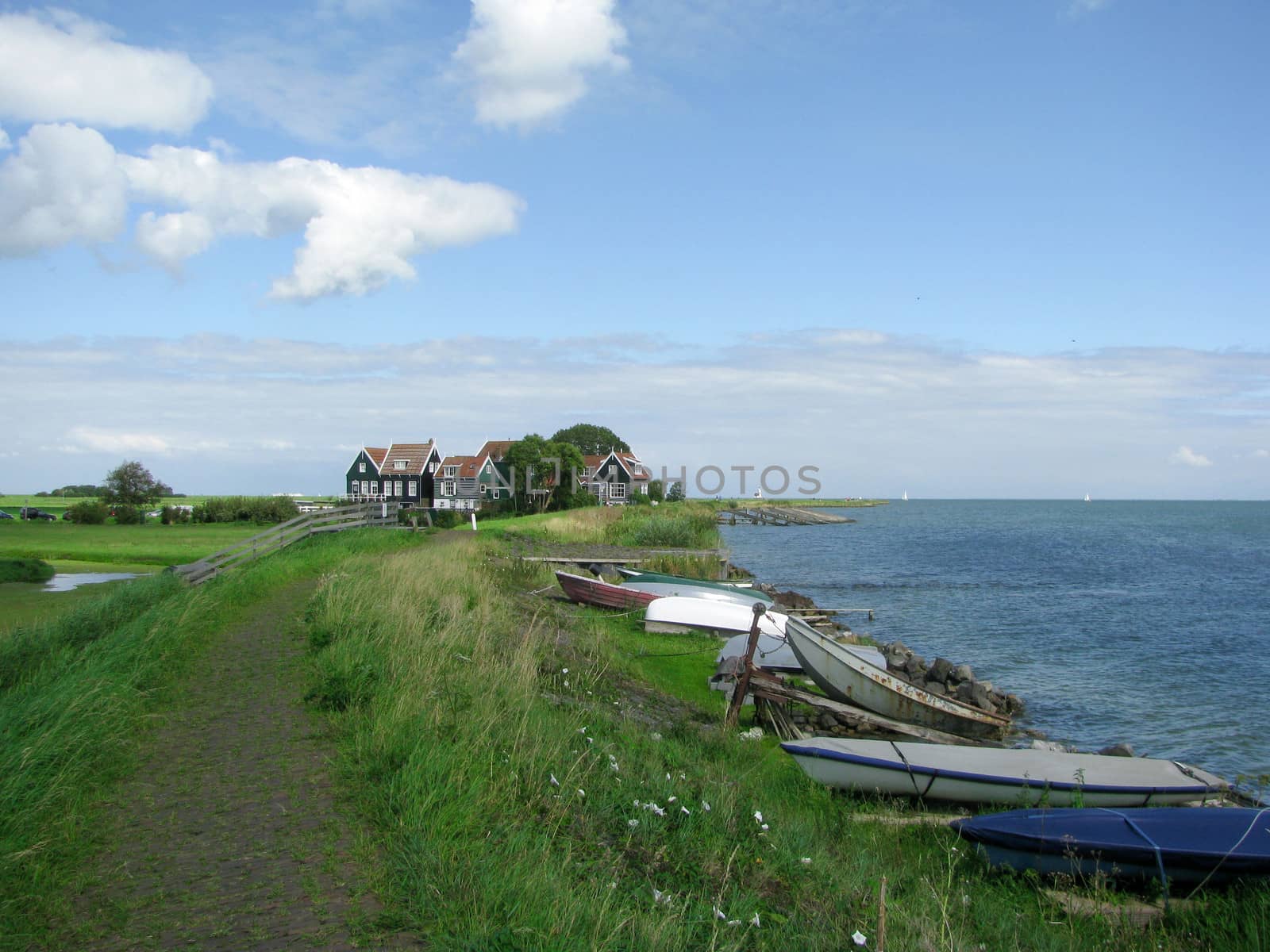 Boats near the footpath to houses, the Netherlands by Tetyana