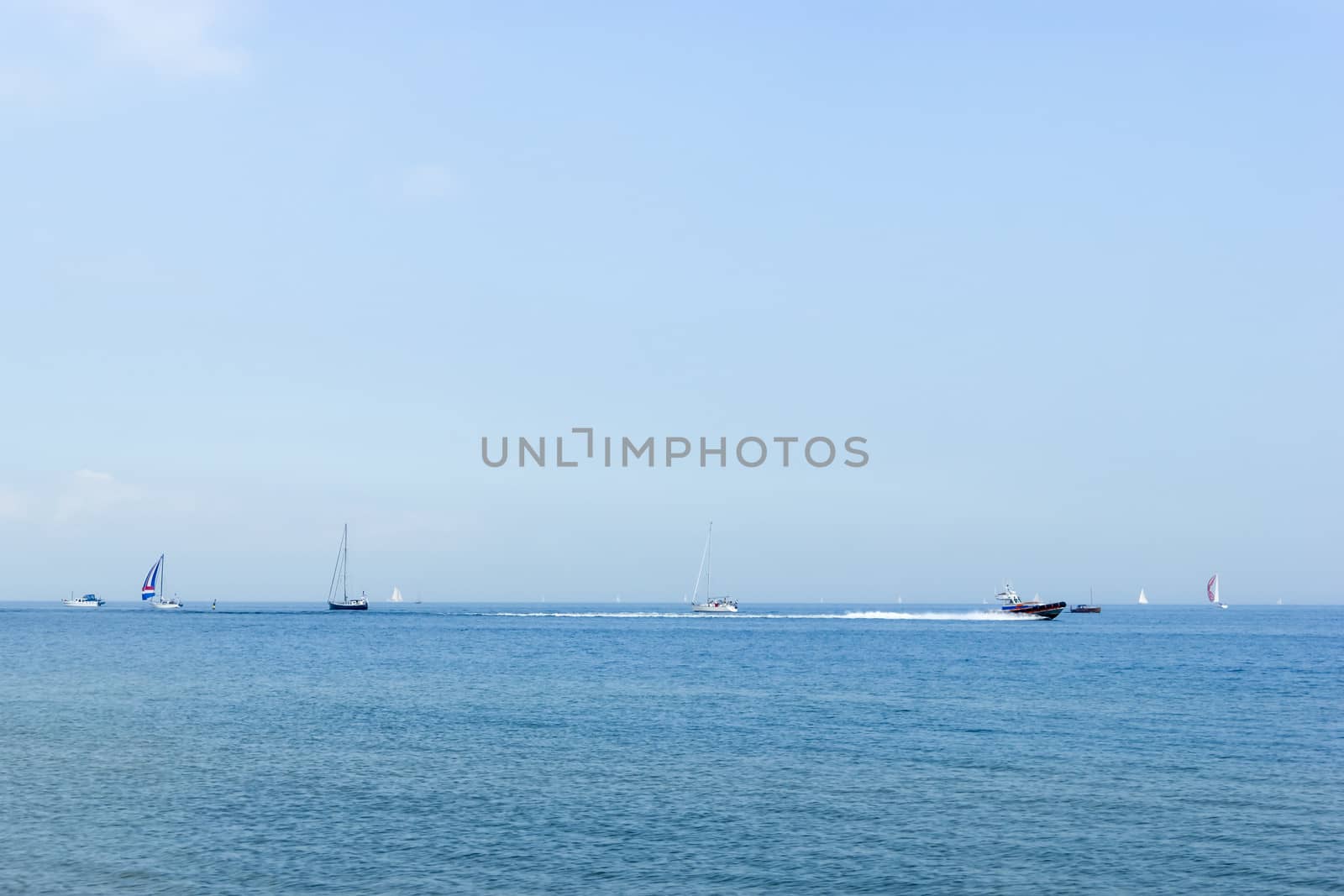 Seascape with sailboat the background of the blue sky. by Tetyana