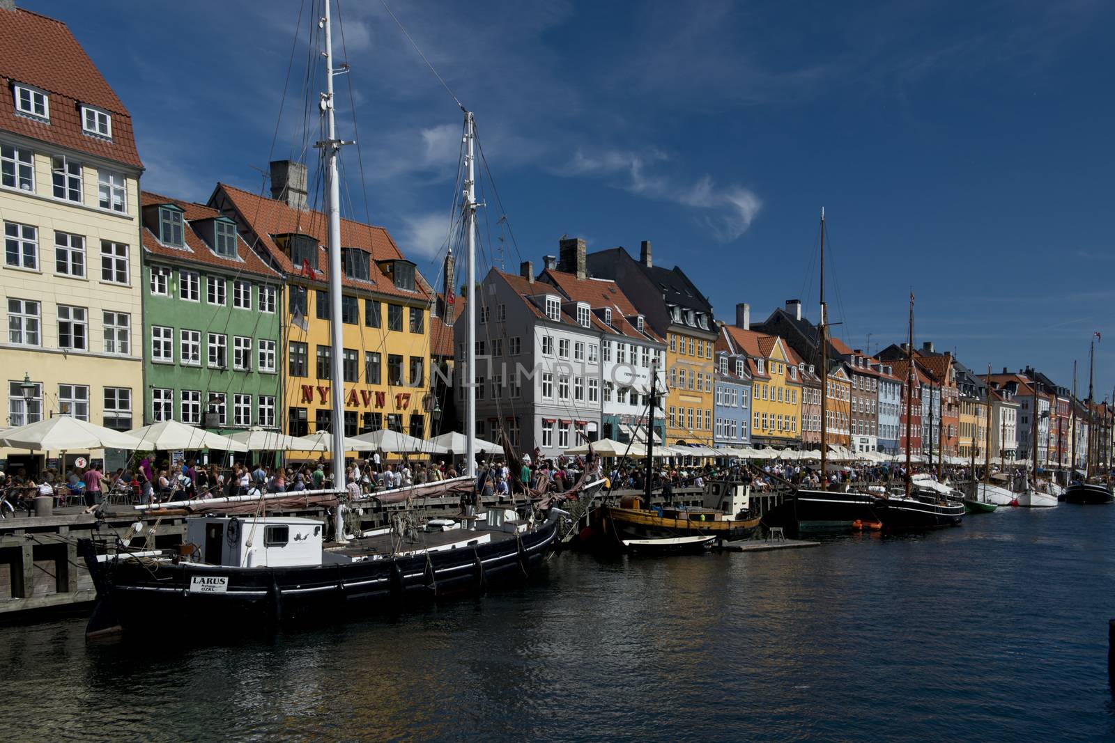 the skyline of the nyhavn, historical channel in the center of Copenhagen, Denmark, full of ancient multicolored houses