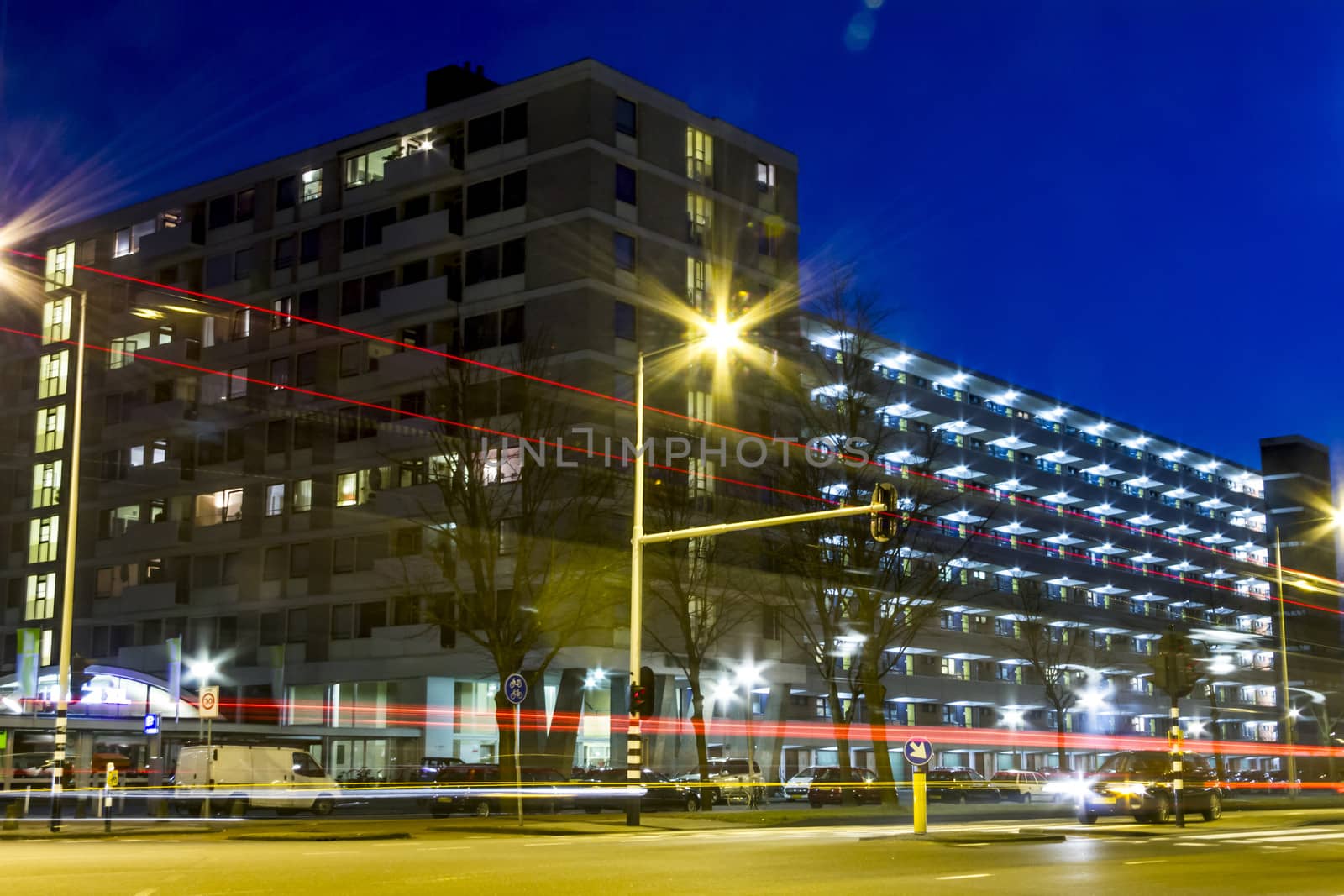 traffic through modern city at night in Amsterdam by Tetyana