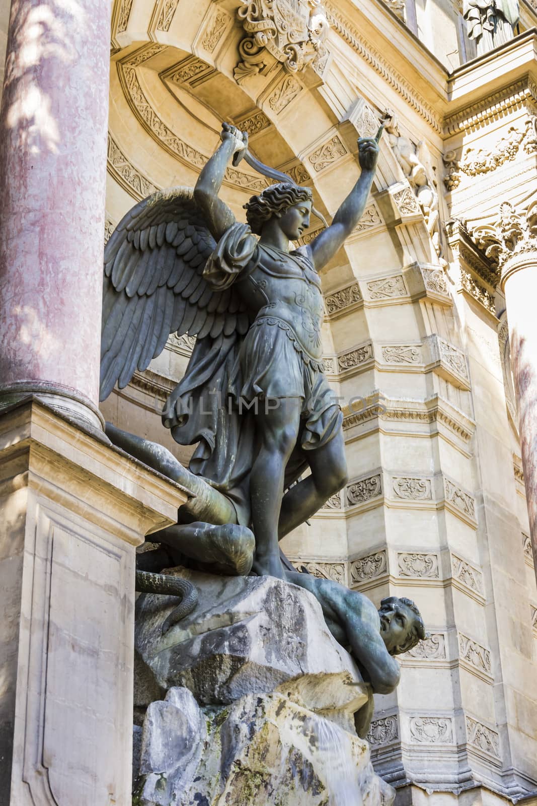 Fountain Saint-Michel at Place Saint-Michel in Paris, France. It was constructed in 1858-1860 during French Second Empire by architect Gabriel Davioud. Archangel Michael and devil by Francisque Duret.