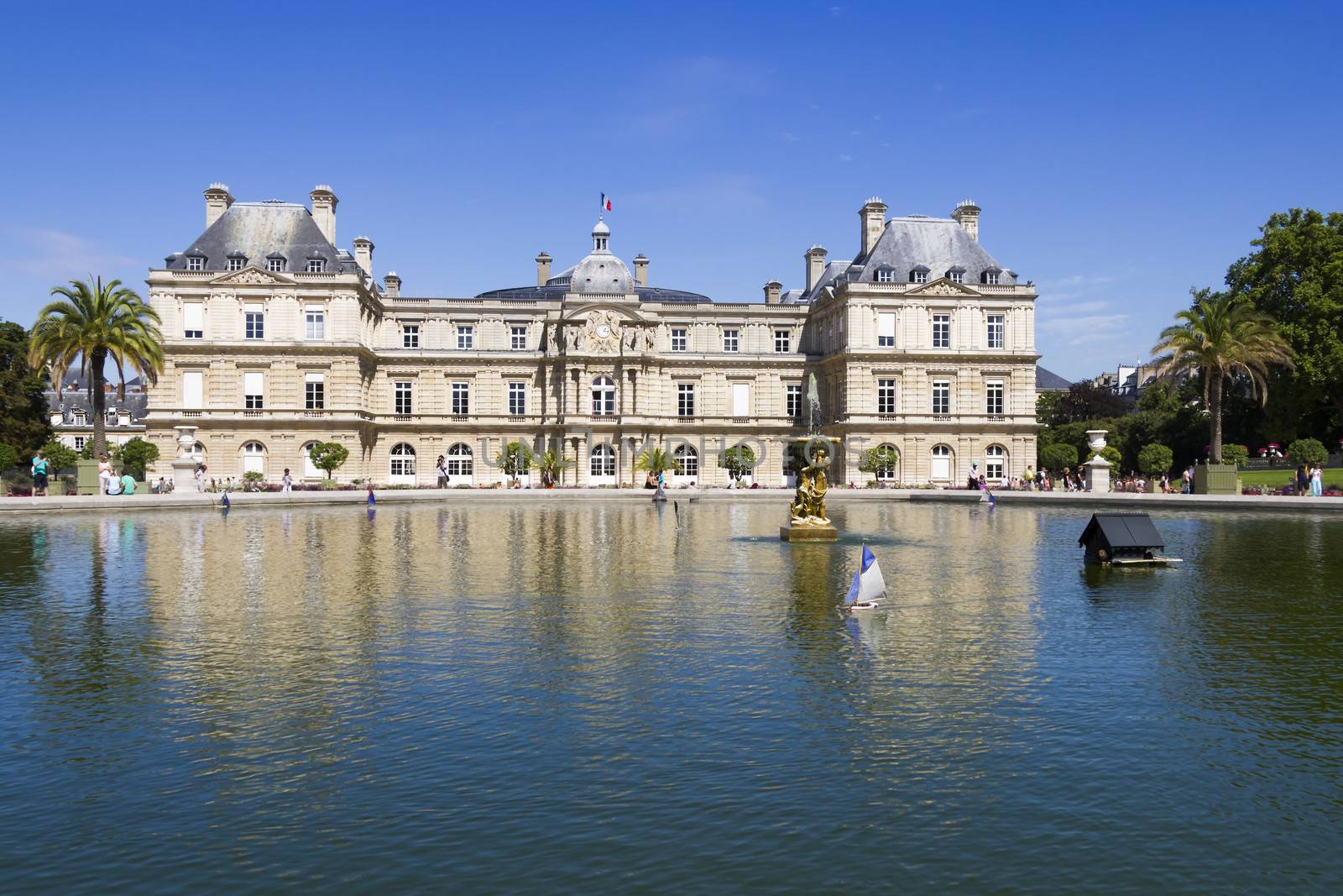 Traditional small wooden sailing boat in the pond of park Jardin du Luxembourg, Paris, France