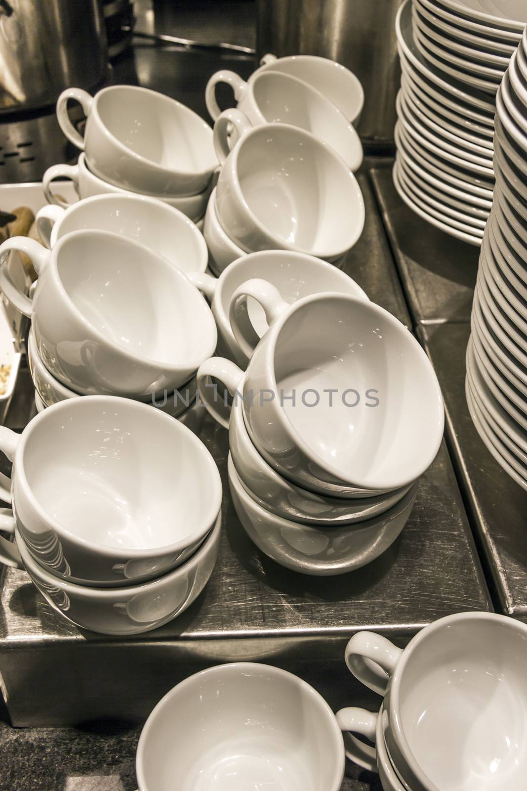 Stacks of white bowls against a restaurant background