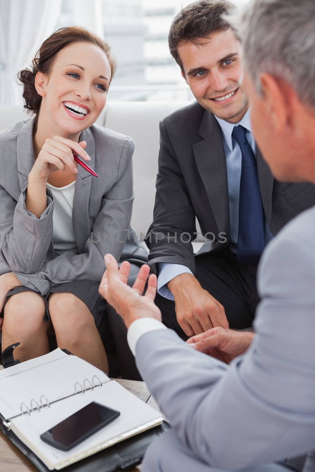 Business people arranging an appointment in cosy meeting room