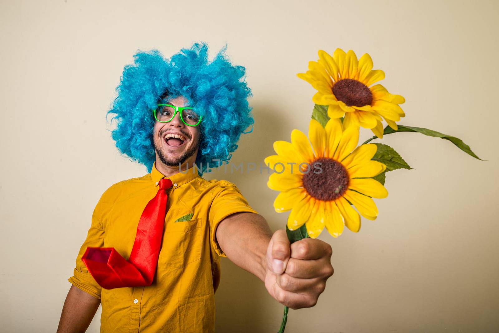 crazy funny young man with blue wig on white background