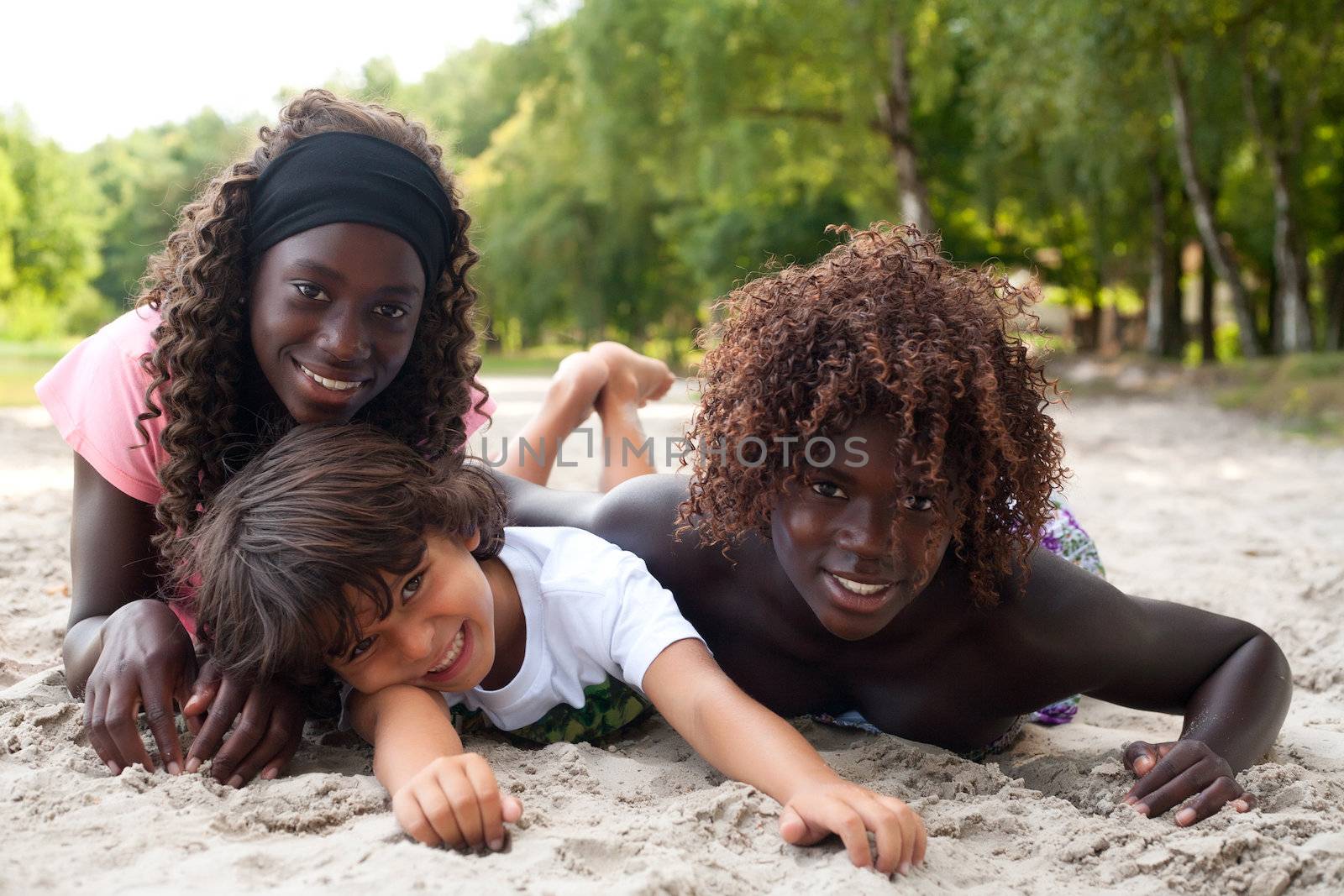 Smiling ethnic children on the beach by DNFStyle