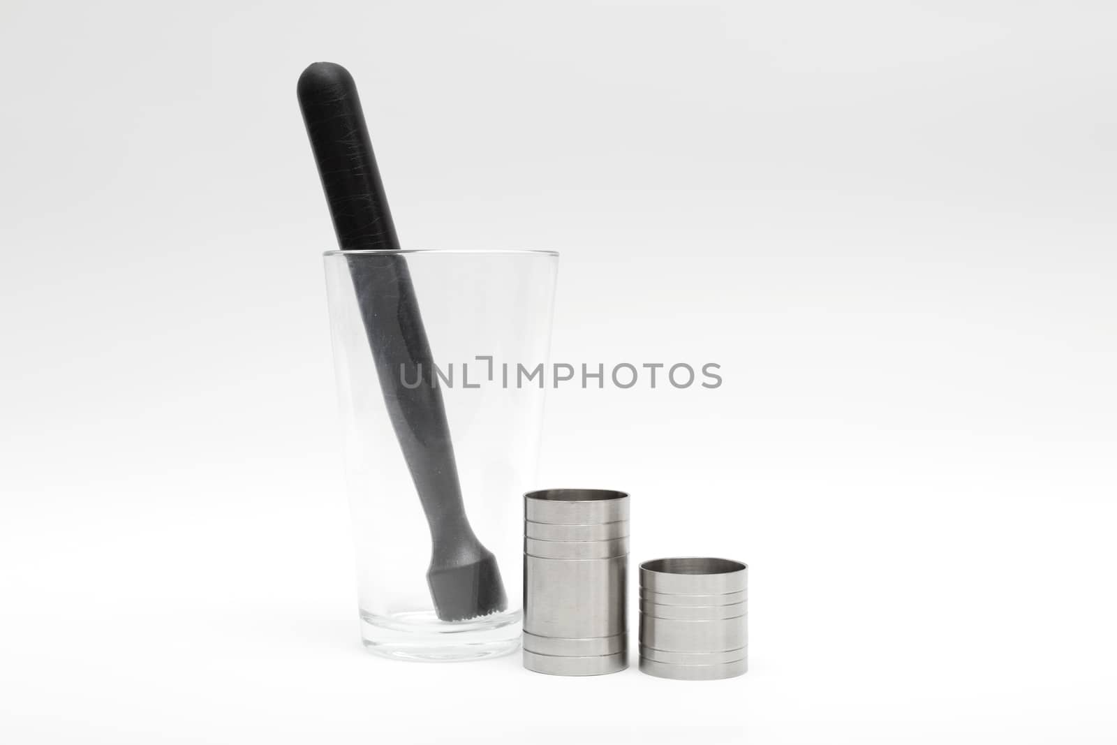 Various cocktail mixing utensils on a white background