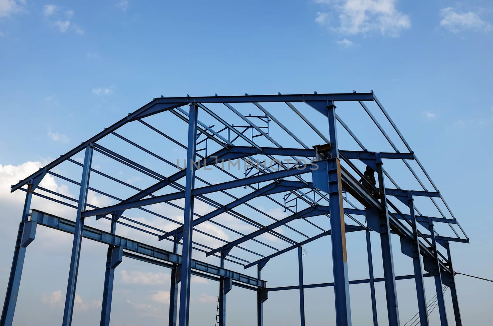 Steel frame of a new industrial building by photosoup