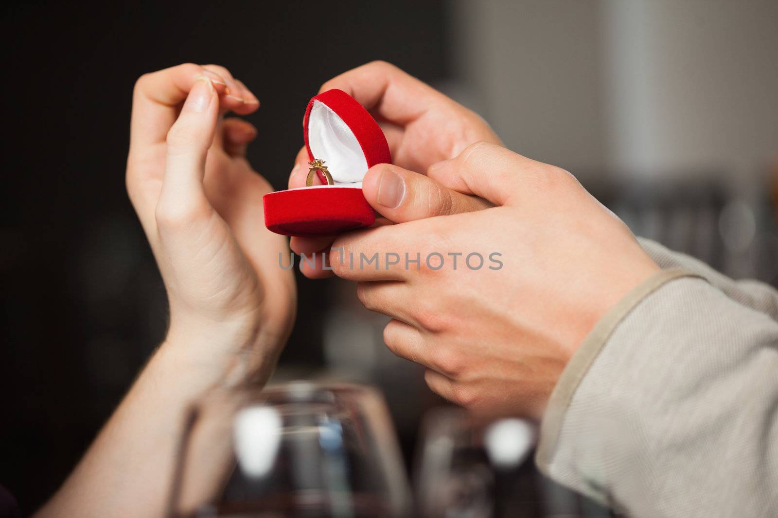 Close up on the ring during marriage proposal in a classy restaurant