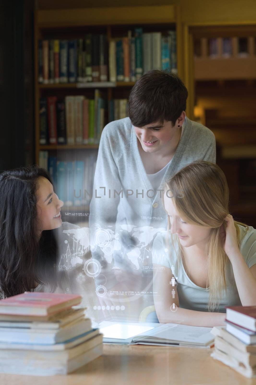 Happy students working together with futuristic interface in university library