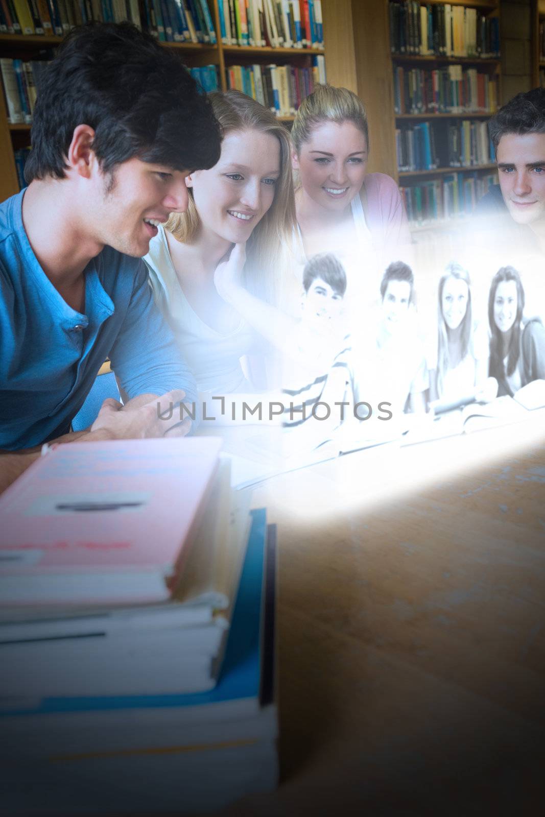 Happy college friends watching photos on futuristic interface in university library